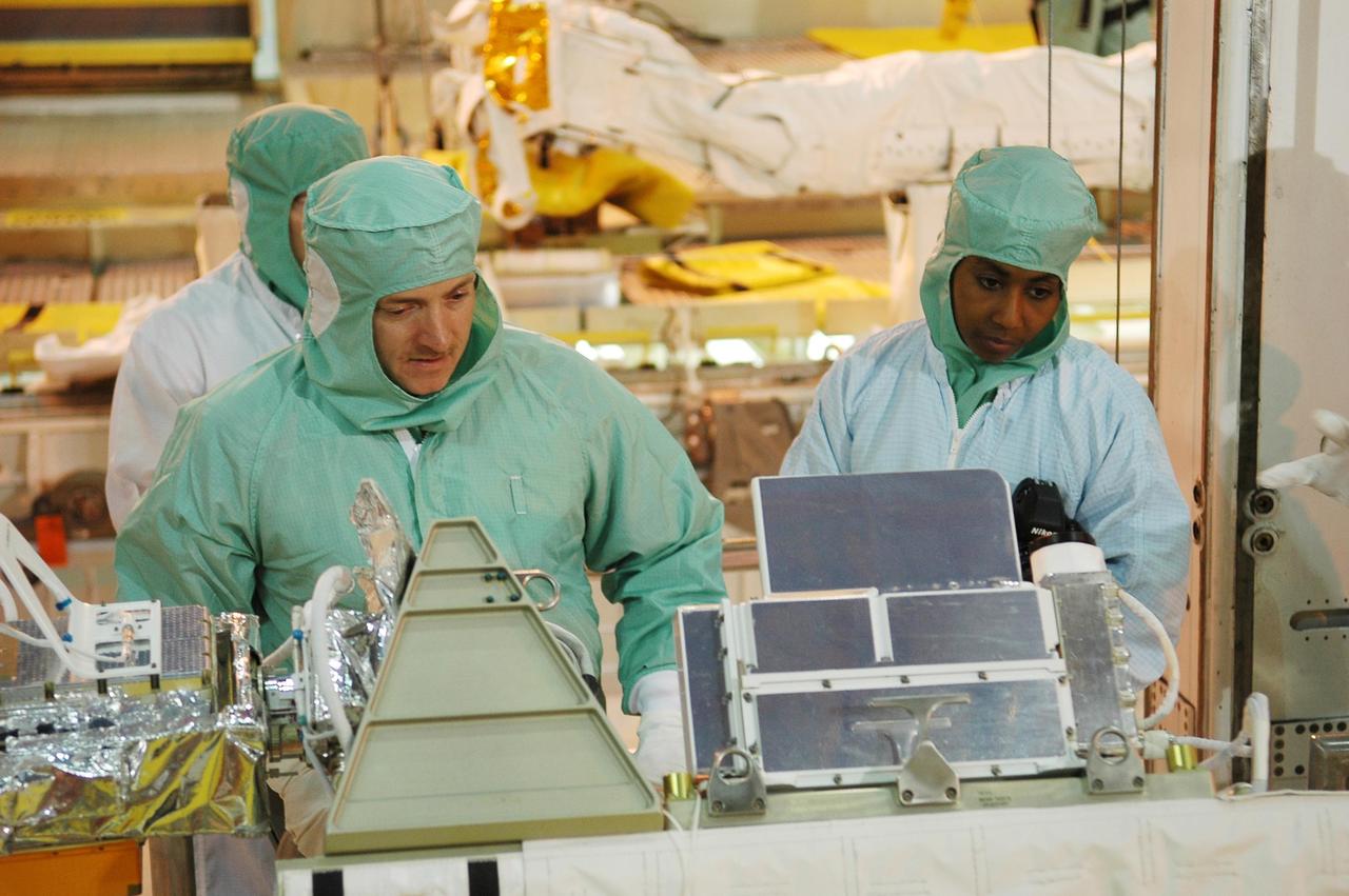 KENNEDY SPACE CENTER, FLA. - In NASA Kennedy Space Center's Orbiter Processing Facility bay 3, STS-121 Pilot Mark Kelly and Mission Specialist Stephanie Wilson work with equipment that will be on the mission.  The crew is at Kennedy to take part in the crew equipment interface test, which provides hands-on experience with equipment to be used on-orbit.  Launch of Space Shuttle Discovery on mission STS-121, the second return-to-flight mission, is scheduled no earlier than May.