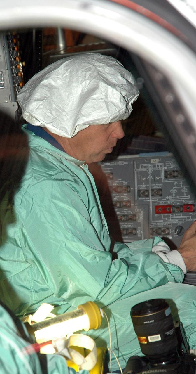 KENNEDY SPACE CENTER, FLA. - In NASA Kennedy Space Center's Orbiter Processing Facility bay 3, STS-121 Commander Steve Lindsey inspects one of the windows that will fly on Space Shuttle Discovery during the mission. The crew is at Kennedy to take part in the crew equipment interface test, which provides hands-on experience with equipment to be used on-orbit. Launch of Space Shuttle Discovery on mission STS-121, the second return-to-flight mission, is scheduled no earlier than May.