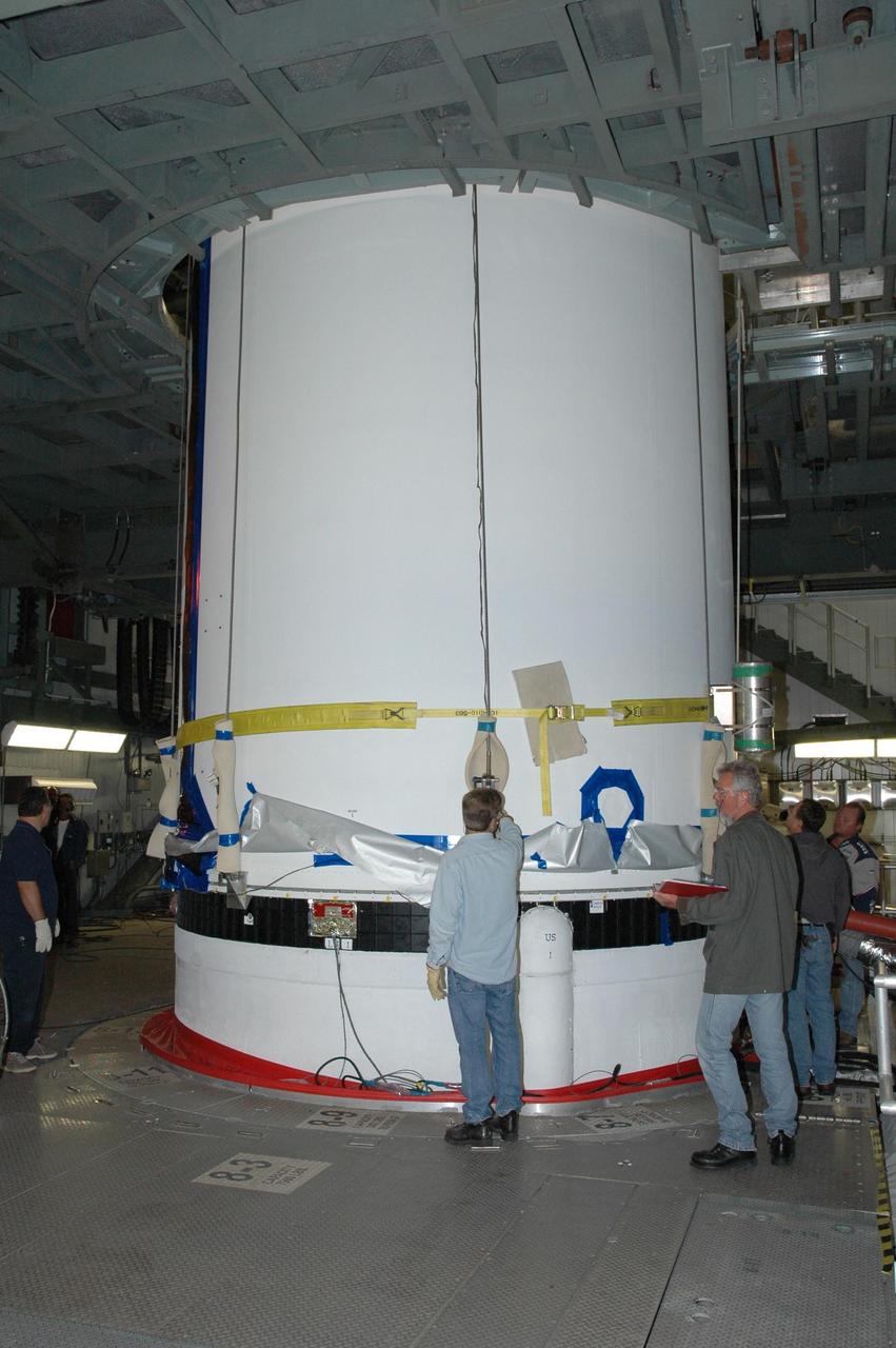 KENNEDY SPACE CENTER, FLA. - On Launch Complex 37 at Cape Canaveral Air Force Station in Florida, technicians demate the GOES-N satellite from its Boeing Delta IV rocket. Launch of the satellite was postponed in August 2005 due to technical issues and postponed to a later date. Due to the extended length of time the spacecraft has been atop the rocket without launching, the weather satellite is being returned to the Astrotech Space Operations payload processing facility for some precautionary retesting and state-of-health checks. GOES-N is the latest in a series of Geostationary Operational Environmental Satellites for NOAA and NASA providing continuous monitoring necessary for intensive data analysis.  Photo credit: NASA/Jim Grossmann