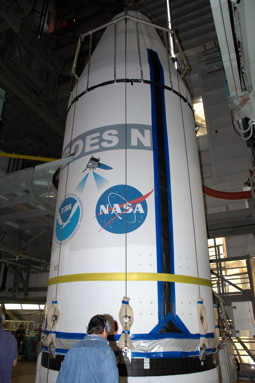 KENNEDY SPACE CENTER, FLA. - On Launch Complex 37 at Cape Canaveral Air Force Station in Florida, the GOES-N satellite is prepared for demating from its Boeing Delta IV rocket. Launch of the satellite was postponed in August 2005 due to technical issues and postponed to a later date. Due to the extended length of time the spacecraft has been atop the rocket without launching, the weather satellite is being returned to the Astrotech Space Operations payload processing facility for some precautionary retesting and state-of-health checks. GOES-N is the latest in a series of Geostationary Operational Environmental Satellites for NOAA and NASA providing continuous monitoring necessary for intensive data analysis.  Photo credit: NASA/Jim Grossmann