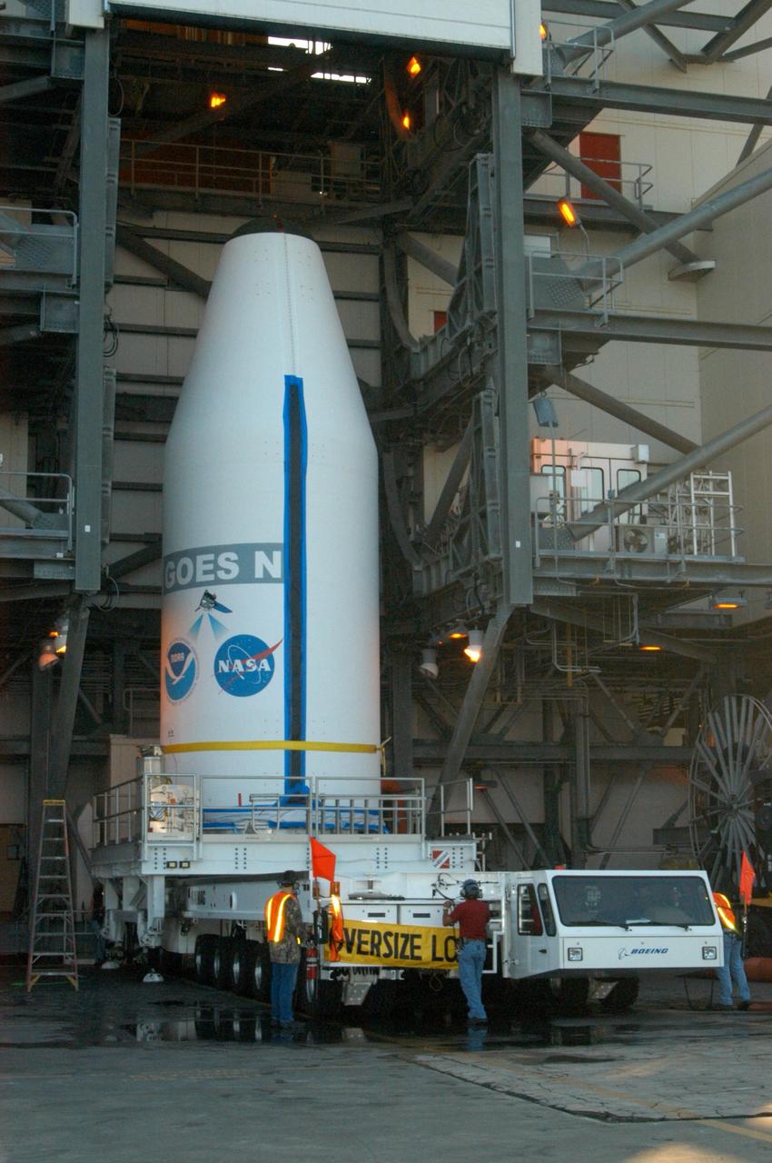 KENNEDY SPACE CENTER, FLA. - On Launch Complex 37 at Cape Canaveral Air Force Station in Florida, the GOES-N spacecraft is secured to a transporter for its transfer back to Astrotech Space Operations in Titusville, Fla., after being demated from the Boeing Delta IV launch vehicle. Launch of the satellite was scrubbed in August 2005 due to technical issues and postponed to a later date. Due to the extended length of time the spacecraft has been atop the rocket without launching, the weather satellite is being returned to the Astrotech payload processing facility for some precautionary retesting and state-of-health checks. GOES-N is the latest in a series of Geostationary Operational Environmental Satellites for NOAA and NASA providing continuous monitoring necessary for intensive data analysis. Photo credit: NASA/George Shelton