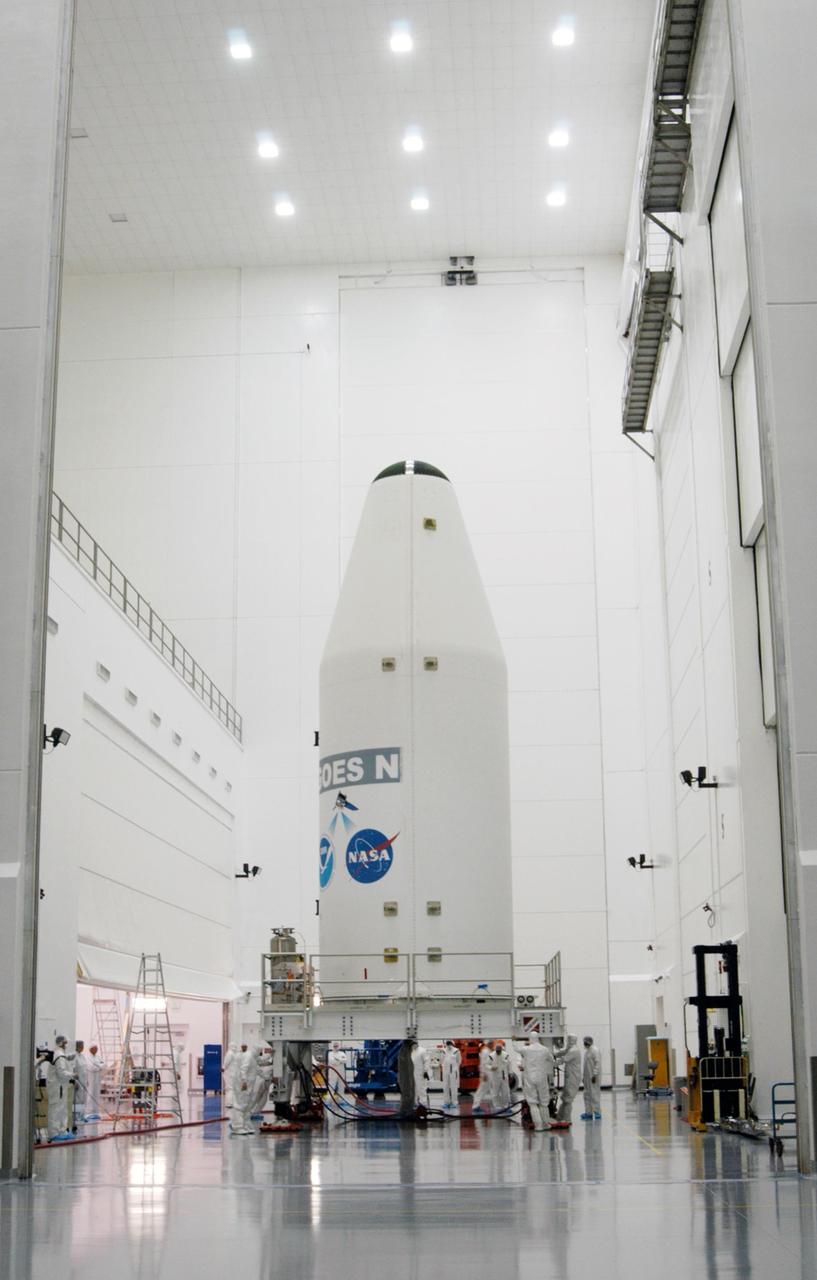 KENNEDY SPACE CENTER, FLA. - At the Astrotech Space Operations payload processing facility in Titusville, Fla., the GOES-N satellite, secured inside a payload fairing, is moved to another high bay area and waiting work stands. Due to the extended length of time the spacecraft had been atop its Boeing Delta IV rocket without launching, the weather satellite has been returned to Astrotech for some precautionary retesting and state of health checks. Liftoff of the satellite from Launch Complex 37 at Cape Canaveral Air Force Station in Florida was scrubbed in August 2005 due to technical issues and postponed to a later date. GOES-N is the latest in a series of Geostationary Operational Environmental Satellites for NOAA and NASA providing continuous monitoring necessary for intensive data analysis. Photo credit: NASA/George Shelton