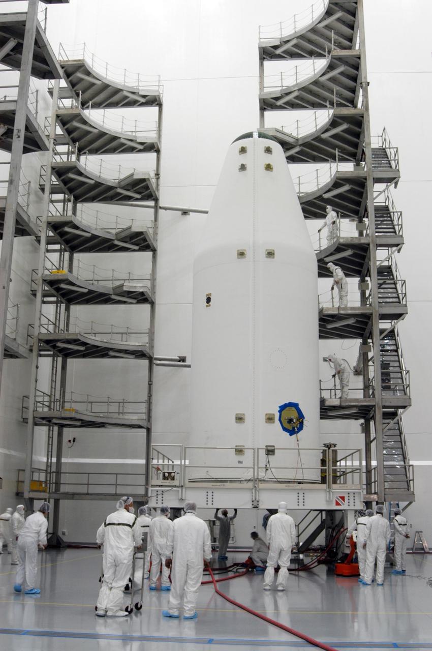 KENNEDY SPACE CENTER, FLA. - At the Astrotech Space Operations payload processing facility in Titusville, Fla., workers monitor the GOES-N satellite, secured inside a payload fairing, as it moves close to the work stands in a clean-room high bay area. Due to the extended length of time the spacecraft had been atop its Boeing Delta IV rocket without launching, the weather satellite has been returned to Astrotech for some precautionary retesting and state of health checks. Liftoff of the satellite from Launch Complex 37 at Cape Canaveral Air Force Station in Florida was scrubbed in August 2005 due to technical issues and postponed to a later date. GOES-N is the latest in a series of Geostationary Operational Environmental Satellites for NOAA and NASA providing continuous monitoring necessary for intensive data analysis. Photo credit: NASA/George Shelton