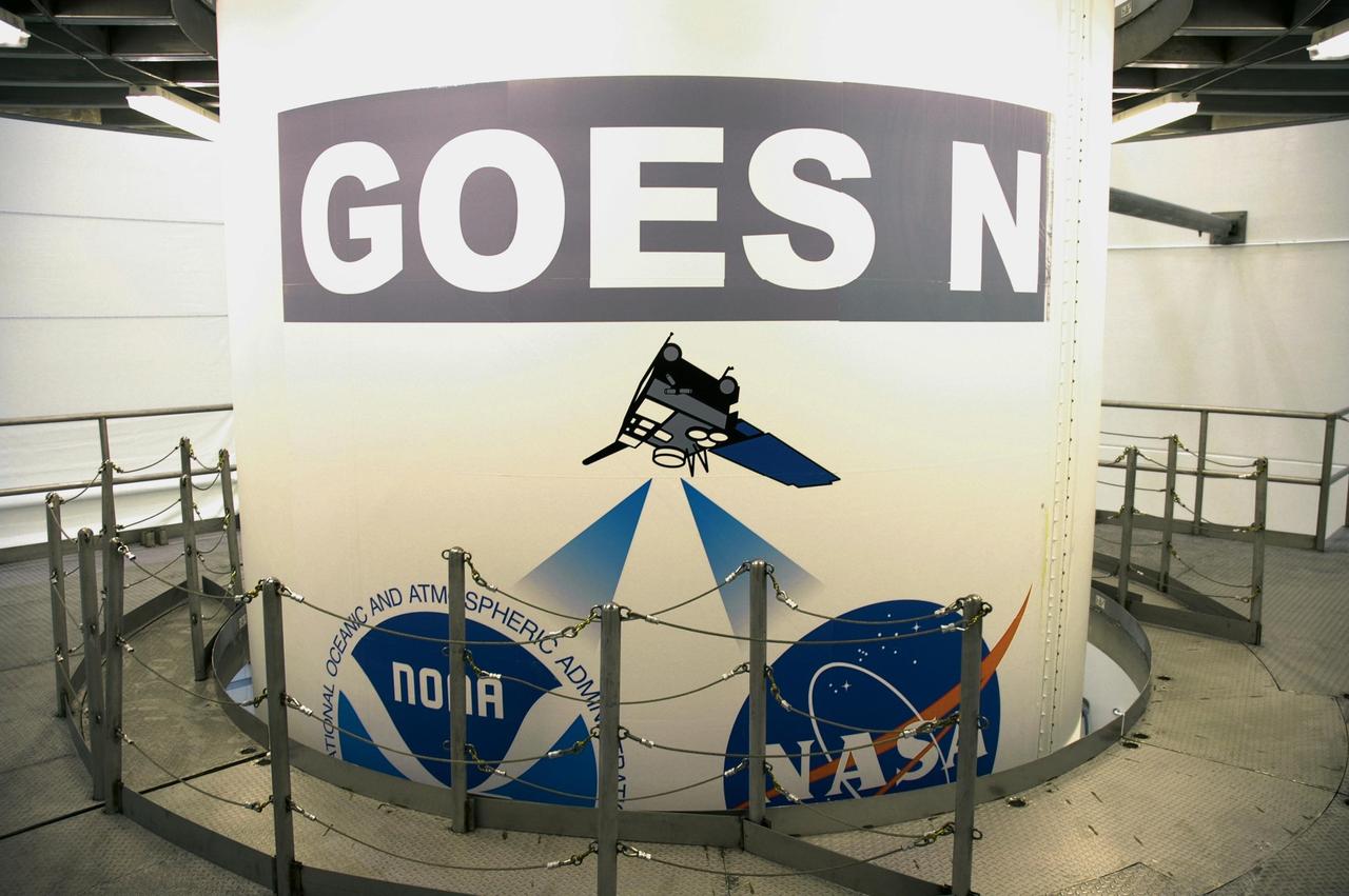 KENNEDY SPACE CENTER, FLA. - At Astrotech Space Operations payload processing facility in Titusville, Fla., the GOES-N spacecraft, secured inside a payload fairing, is surrounded by a work stand. Workers will use the stand to begin detaching the fairing from around the spacecraft. The fairing protects the spacecraft during launch and flight through the atmosphere. Once out of the atmosphere, the fairing is jettisoned. Removing the fairing will allow workers access to the spacecraft. GOES-N was demated from its Boeing Delta IV launch vehicle when the launch was postponed in August 2005 due to technical issues. Due to the extended length of time the spacecraft had been atop the Delta IV rocket without launching, the weather satellite was returned to Astrotech for some precautionary retesting and state of health checks. GOES-N is the latest in a series of Geostationary Operational Environmental Satellites for NOAA and NASA providing continuous monitoring necessary for intensive data analysis. Photo credit: NASA/Jim Grossmann