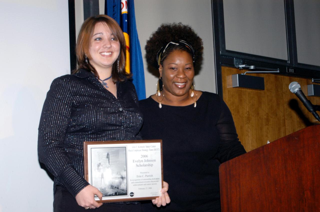 KENNEDY SPACE CENTER, FLA. -  At NASA Kennedy Space Center's annual BEST (Black Employee Strategy Team) African-American History Month luncheon, Erin Parrish (left) displays a plaque she received from Elaine Johnson (right) that names Parrish the recipient of the Evelyn Johnson Scholarship.  Elaine Johnson is the daughter of Evelyn Johnson, one of the organization's founding members.  The Evelyn Johnson Scholarship is given each year by BEST in honor and memory of Evelyn Johnson.  Stay-In-School and coop students at Kennedy as well as dependents of KSC civil service employees are eligible.  The theme for this year's luncheon was "Creating New Paths From Journeys Past."  The luncheon was held in the Kurt H. Debus Center at Kennedy Space Center's Visitor Complex.  Photo credit: NASA/George Shelton