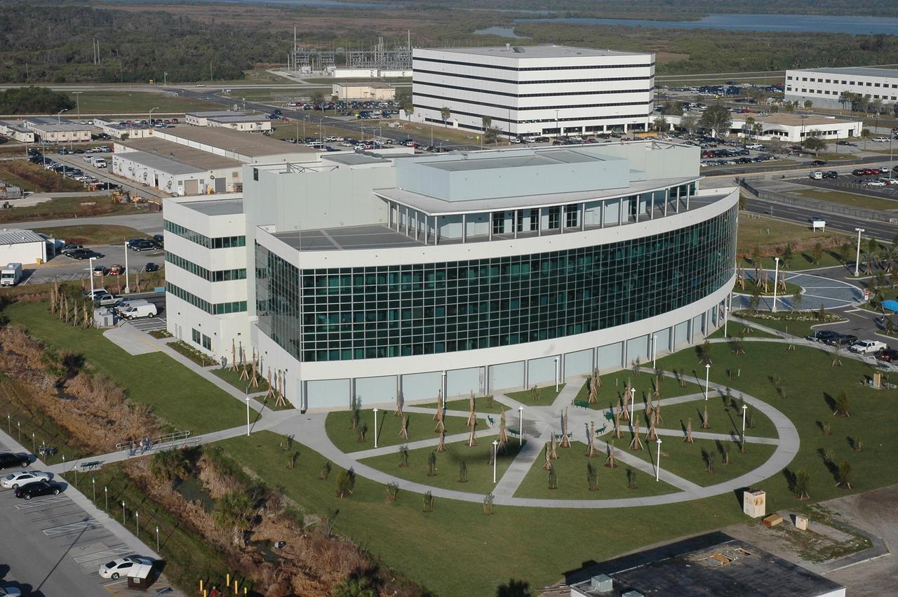 KENNEDY SPACE CENTER, FLA.  -    The Operations Support Building II at NASA's Kennedy Space Center is seen here, newly built and landscaped.  The building replaced modular housing and trailers in the Launch Complex 39 area.  The five-story, 189,000-square-foot building consists of approximately 860 office spaces, training rooms, computer rooms, multimedia conference rooms, technical libraries, and a 352-person mission conference center with observation deck.   Photo credit: Cory Huston