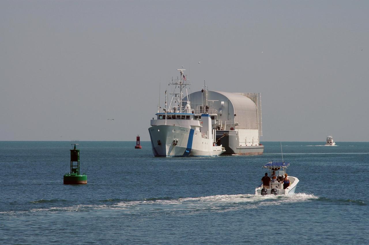 KENNEDY SPACE CENTER, FLA.  - Towed by the Freedom Star, the Pegasus barge enters Port Canaveral, the last leg of its journey from the Michoud Assembly Facility in New Orleans to Kennedy Space Center.  The barge carries the redesigned external fuel tank that will launch Space Shuttle Discovery on the next shuttle mission, STS-121.  After off-loading, the tank will be moved into the Vehicle Assembly Building and lifted into a checkout cell for further work. The tank, designated ET-119, will fly with many major safety changes, including the removal of the protuberance air load ramps. A large piece of foam from a ramp came off during the last shuttle launch in July 2005. The ramps were removed to eliminate a potential source of damaging debris to the space shuttle.  The next launch of Discovery is scheduled for May 2006.
