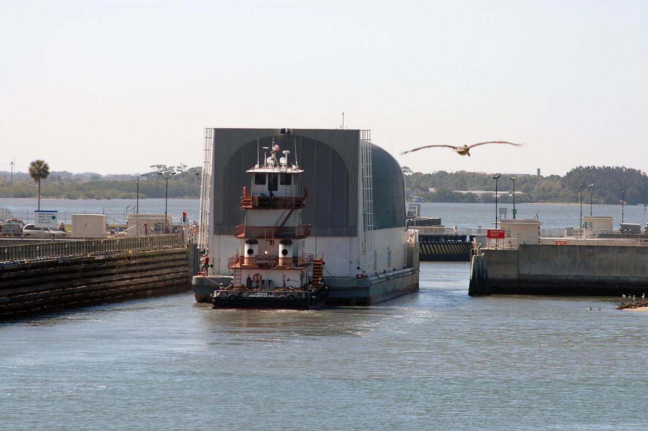 KENNEDY SPACE CENTER, FLA.  - The Pegasus barge traverses the locks at Port Canaveral, as it nears the end of its journey from the Michoud Assembly Facility in New Orleans to Kennedy Space Center.  The barge carries the redesigned external fuel tank that will launch Space Shuttle Discovery on the next shuttle mission, STS-121.  After off-loading, the tank will be moved into the Vehicle Assembly Building and lifted into a checkout cell for further work. The tank, designated ET-119, will fly with many major safety changes, including the removal of the protuberance air load ramps. A large piece of foam from a ramp came off during the last shuttle launch in July 2005. The ramps were removed to eliminate a potential source of damaging debris to the space shuttle.  The next launch of Discovery is scheduled for May 2006.