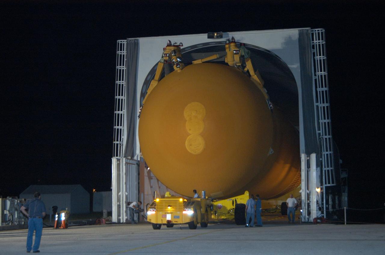KENNEDY SPACE CENTER, FLA.  - Off-loading of the redesigned external fuel tank that will launch Space Shuttle Discovery on the next shuttle mission, STS-121, begins in the Launch Complex 39 turn basin. The Pegasus barge delivered the tank from the Michoud Assembly Facility in New Orleans to NASA's Kennedy Space Center. After off-loading, the tank will be moved into the Vehicle Assembly Building and lifted into a checkout cell for further work.  The tank, designated ET-119, will fly with many major safety changes, including the removal of the protuberance air load ramps. A large piece of foam from a ramp came off during the last shuttle launch in July 2005. The ramps were removed to eliminate a potential source of damaging debris to the space shuttle.  The next launch of Discovery is scheduled for May 2006.