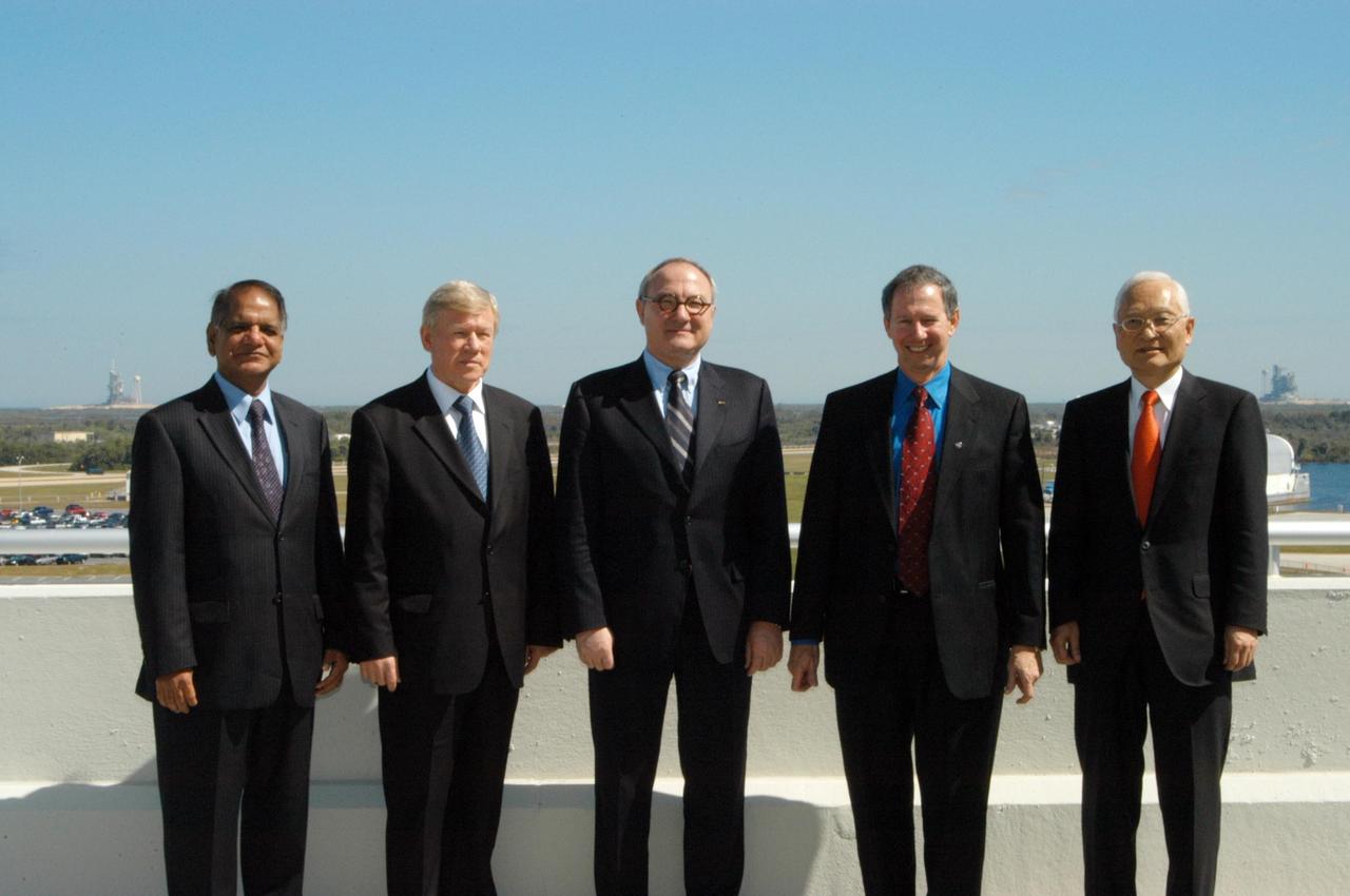 KENNEDY SPACE CENTER, FLA.  - Leaders from space agencies around the world take a moment from the International Space Station Heads of Agency meeting being held at Kennedy Space Center for a group portrait, framed by the space shuttle launch pads in Launch Complex 39. From left are Canadian Space Agency Vice-President Space Science, Technology and Programs Virendra Jha; Russian Federal Space Agency Head Anatolii Perminov; European Space Agency Director-General Jean-Jacques Dordain; NASA Administrator Michael Griffin; and Japan Aerospace Exploration Agency President Keiji Tachikawa.  The purpose of the meeting is to review International Space Station cooperation and endorse a revision to the station configuration and assembly sequence.