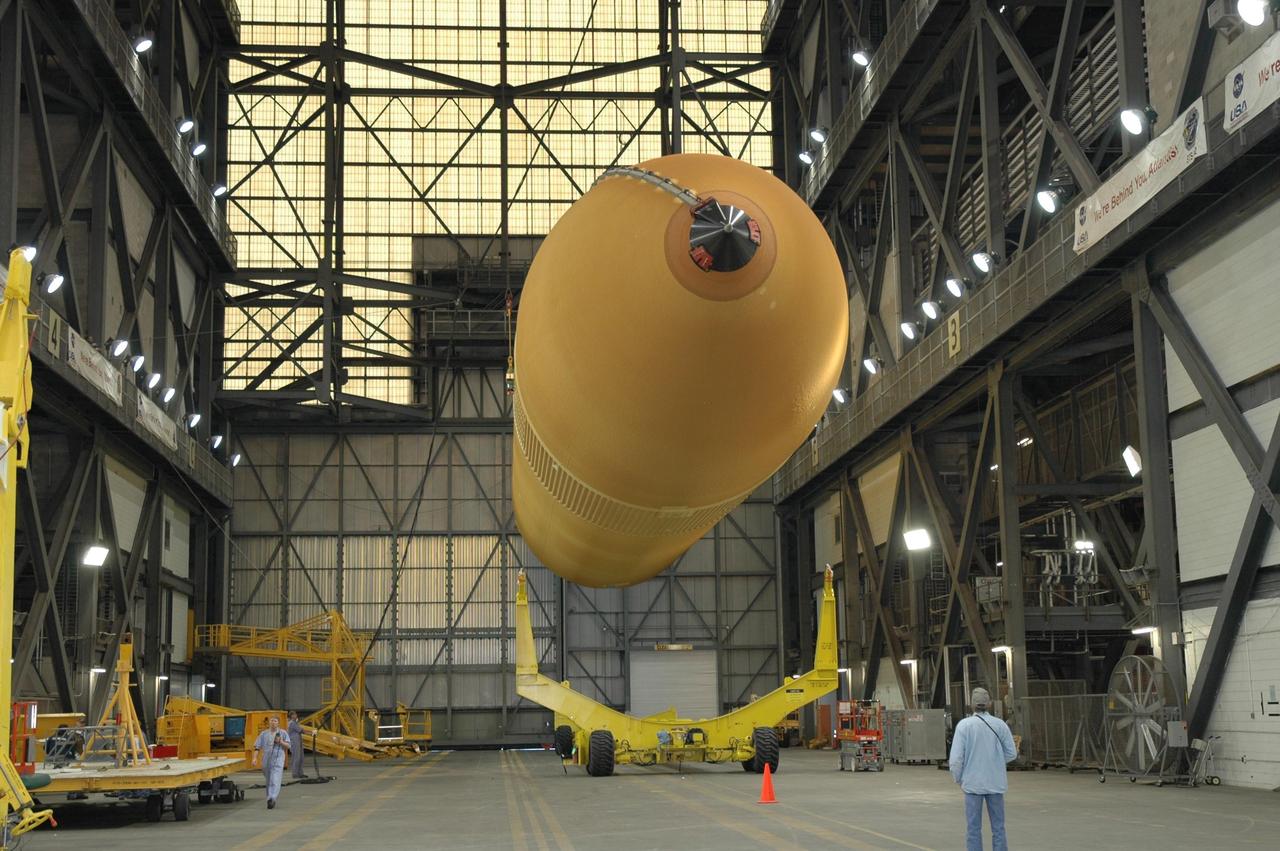 KENNEDY SPACE CENTER, FLA.  -  In NASA Kennedy Space Center's Vehicle Assembly Building, the newly delivered external tank is lifted off its transporter.  Designated ET-119, the 154-foot tank is being raised to vertical and then will be lifted into a checkout cell for further work.  The tank, which will launch space shuttle Discovery on mission STS-121, will fly with many major safety changes, including the removal of the protuberance air load ramps. A large piece of foam from a ramp came off during the last shuttle launch in July 2005. The ramps were removed to eliminate a potential source of damaging debris to the space shuttle. The next launch of Discovery is scheduled for May 2006. Photo credit: NASA/Jim Grossmann