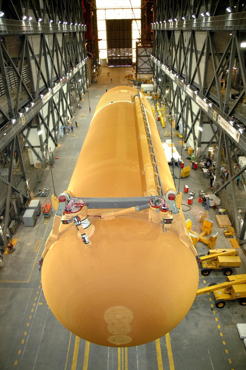 KENNEDY SPACE CENTER, FLA. - In NASA Kennedy Space Center's Vehicle Assembly Building, the newly delivered external tank is lifted off its transporter. Designated ET-119, the 154-foot tank is being raised to vertical and then will be lifted into a checkout cell for further work. The tank, which will launch space shuttle Discovery on mission STS-121, will fly with many major safety changes, including the removal of the protuberance air load ramps. A large piece of foam from a ramp came off during the last shuttle launch in July 2005. The ramps were removed to eliminate a potential source of damaging debris to the space shuttle. The next launch of Discovery is scheduled for May 2006. Photo credit: NASA/Jim Grossmann
