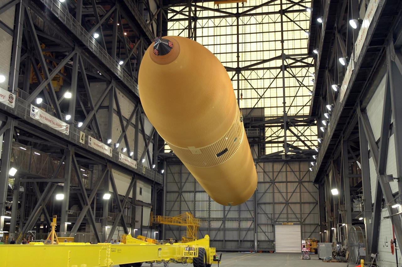 KENNEDY SPACE CENTER, FLA.  -  In NASA Kennedy Space Center's Vehicle Assembly Building, the newly delivered external tank is lifted off its transporter.  Designated ET-119, the 154-foot tank is being raised to vertical and then will be lifted into a checkout cell for further work.  The tank, which will launch space shuttle Discovery on mission STS-121, will fly with many major safety changes, including the removal of the protuberance air load ramps. A large piece of foam from a ramp came off during the last shuttle launch in July 2005. The ramps were removed to eliminate a potential source of damaging debris to the space shuttle. The next launch of Discovery is scheduled for May 2006. Photo credit: NASA/Jim Grossmann