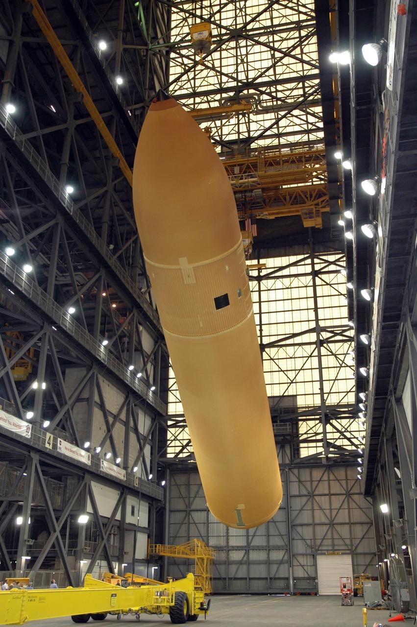 KENNEDY SPACE CENTER, FLA.  -  In NASA Kennedy Space Center's Vehicle Assembly Building, the newly delivered external tank has been raised nearly to vertical.  Designated ET-119, the 154-foot tank will be lifted into a checkout cell for further work. The tank, which will launch space shuttle Discovery on mission STS-121, will fly with many major safety changes, including the removal of the protuberance air load ramps. A large piece of foam from a ramp came off during the last shuttle launch in July 2005. The ramps were removed to eliminate a potential source of damaging debris to the space shuttle. The next launch of Discovery is scheduled for May 2006. Photo credit: NASA/Jim Grossmann