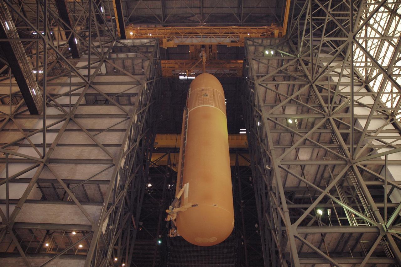 KENNEDY SPACE CENTER, FLA. - In the upper regions of NASA Kennedy Space Center's Vehicle Assembly Building, the newly delivered external tank is moved over a crossbeam toward a checkout cell for further work. Designated ET-119, the 154-foot tank will be lifted into a checkout cell for further work. The tank, which will launch space shuttle Discovery on mission STS-121, will fly with many major safety changes, including the removal of the protuberance air load ramps. A large piece of foam from a ramp came off during the last shuttle launch in July 2005. The ramps were removed to eliminate a potential source of damaging debris to the space shuttle. The next launch of Discovery is scheduled for May 2006. Photo credit: NASA/Jim Grossmann