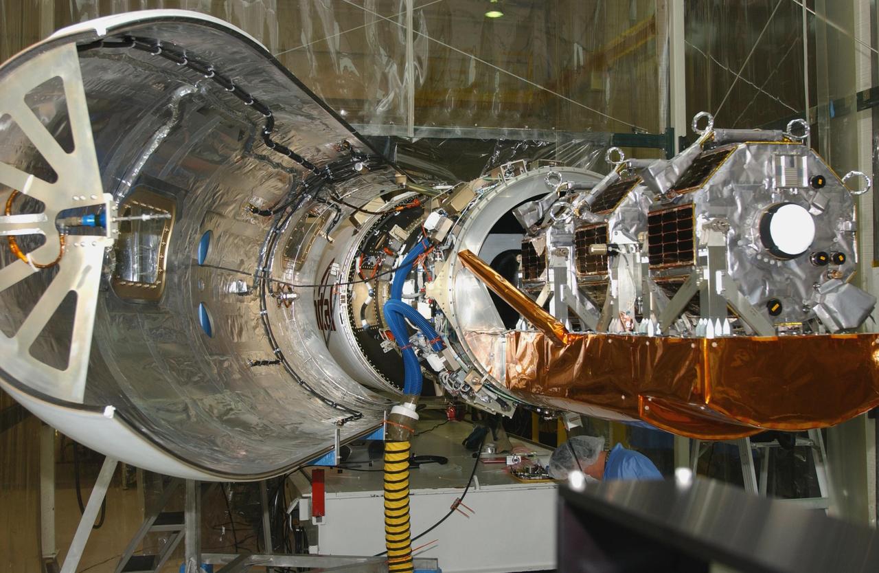 VANDENBERG AIR FORCE BASE, CALIF. - Inside Orbital Sciences’ Building 1555 at Vandenberg Air Force Base in California, the Space Technology 5 (ST5) spacecraft waits for encapsulation after mating with the Orbital Sciences' Pegasus XL launch vehicle.  The ST5 contains three microsatellites with miniaturized redundant components and technologies.  Each will validate New Millennium Program selected technologies, such as the Cold Gas Micro-Thruster and X-Band Transponder Communication System.  After deployment from the Pegasus, the micro-satellites will be positioned in a “string of pearls” constellation that demonstrates the ability to position them to perform simultaneous multi-point measurements of the magnetic field using highly sensitive magnetometers.  The data will help scientists understand and map the intensity and direction of the Earth’s magnetic field, its relation to space weather events, and affects on our planet.  With such missions, NASA hopes to improve scientists’ ability to accurately forecast space weather and minimize its harmful effects on space- and ground-based systems.  Launch of ST5 is scheduled from the belly of an L-1011 carrier aircraft no earlier than March 14 from Vandenberg Air Force Base.