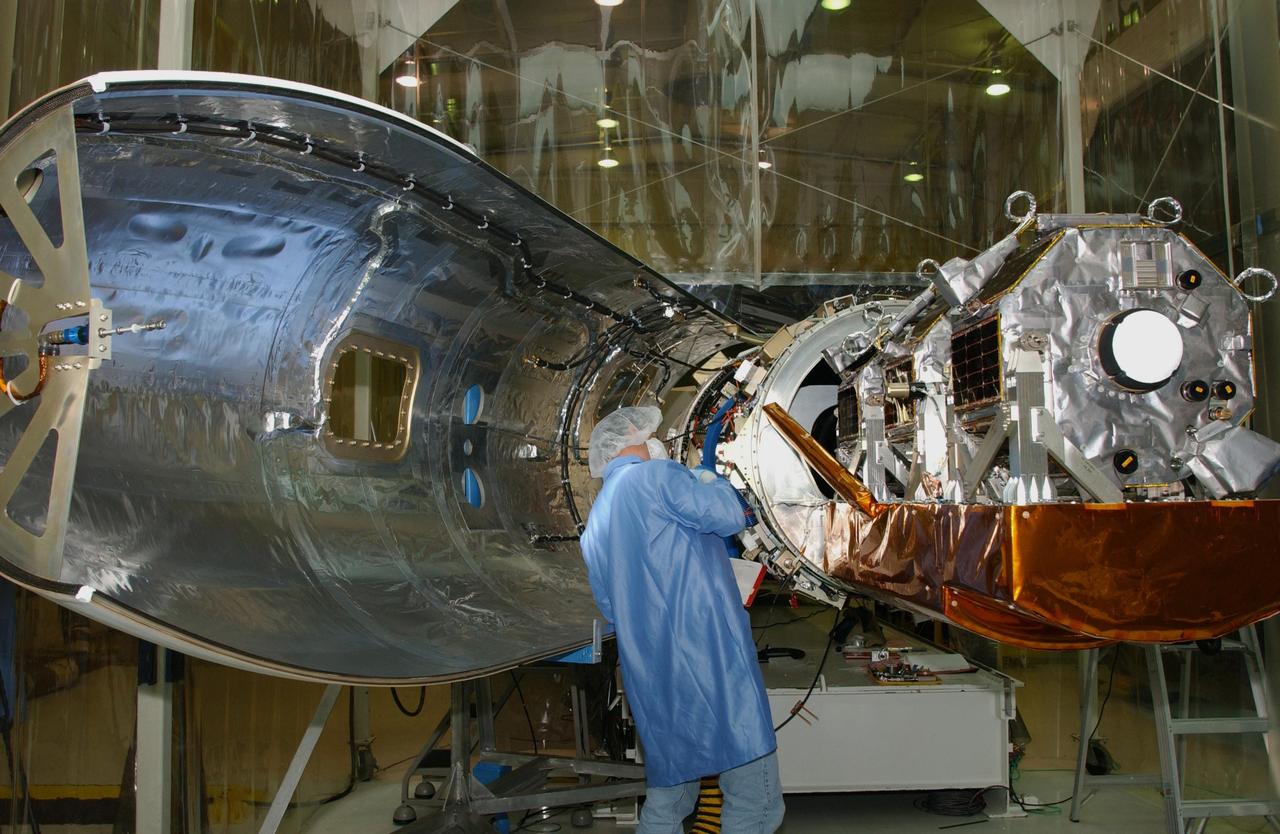 VANDENBERG AIR FORCE BASE, CALIF. - Inside Orbital Sciences’ Building 1555 at Vandenberg Air Force Base in California, a worker completes connections on the Space Technology 5 (ST5) spacecraft before enclosure.  The ST5, mated to Orbital Sciences' Pegasus XL launch vehicle, contains three microsatellites with miniaturized redundant components and technologies.  Each will validate New Millennium Program selected technologies, such as the Cold Gas Micro-Thruster and X-Band Transponder Communication System.  After deployment from the Pegasus, the micro-satellites will be positioned in a “string of pearls” constellation that demonstrates the ability to position them to perform simultaneous multi-point measurements of the magnetic field using highly sensitive magnetometers.  The data will help scientists understand and map the intensity and direction of the Earth’s magnetic field, its relation to space weather events, and affects on our planet.  With such missions, NASA hopes to improve scientists’ ability to accurately forecast space weather and minimize its harmful effects on space- and ground-based systems.  Launch of ST5 is scheduled from the belly of an L-1011 carrier aircraft no earlier than March 14 from Vandenberg Air Force Base.