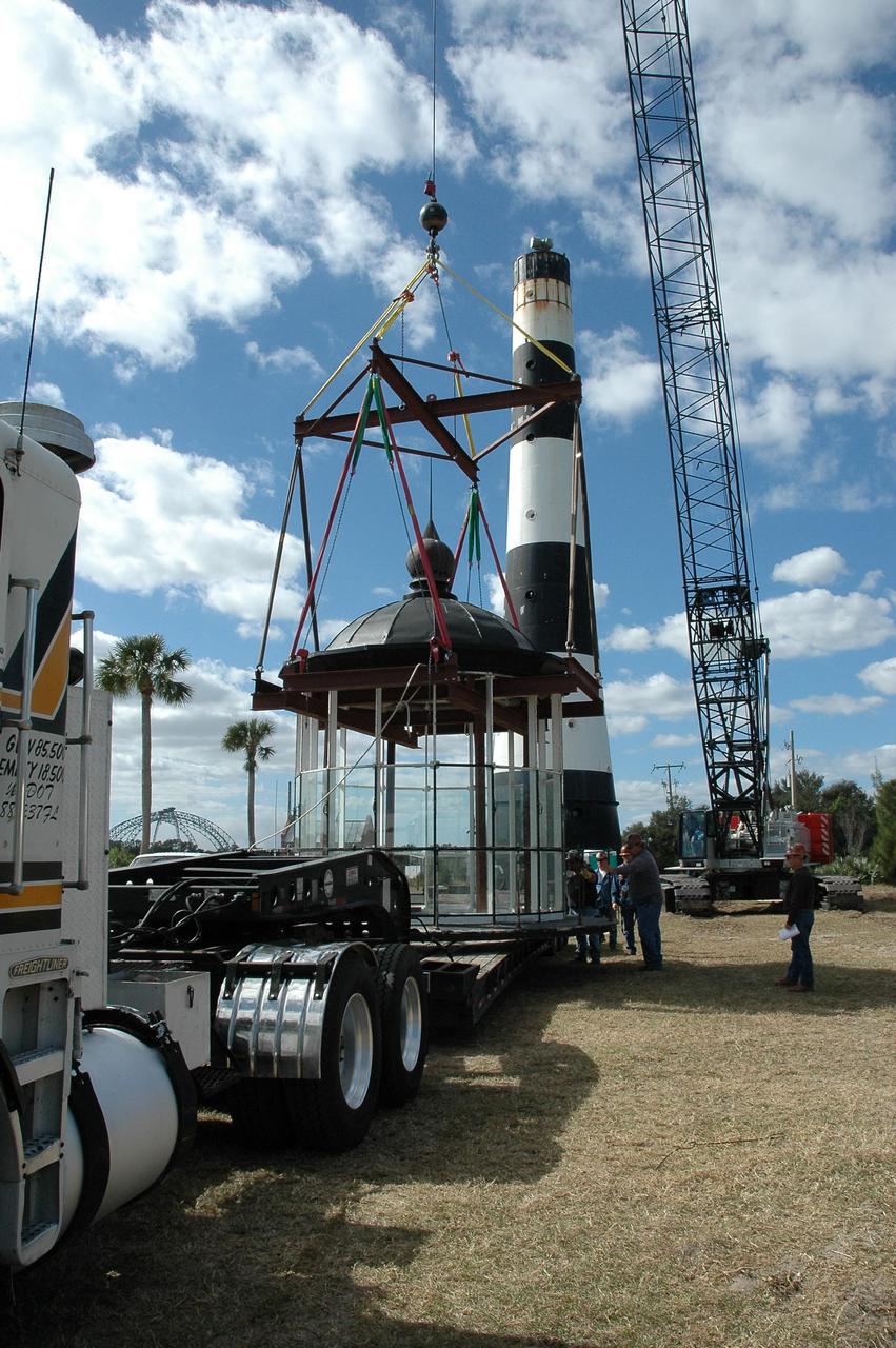 KENNEDY SPACE CENTER, FLA.  - At Cape Canaveral Air Force Station, workers secure the lamp room detached from the Cape Canaveral Lighthouse onto a flat bed truck.  Leaks in the roof allowed moisture to seep in.  The lamp room will be moved to a facility near Cape Canaveral for repairs and renovation. The lamp room is being removed for repairs and refurbishment.  In addition, the original brass roof will be restored and put back in place. The Cape Canaveral Lighthouse is the only operational lighthouse owned by the Air Force. It was first erected in 1868 near the edge of the Atlantic Ocean.  Photo credit: NASA/Jack Pfaller