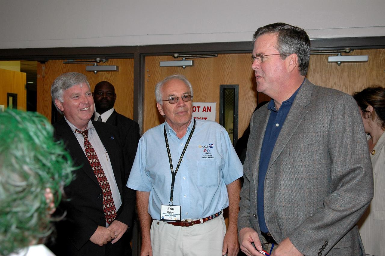 KENNEDY SPACE CENTER, FLA. - During the 2006 FIRST Robotics Regional Competition held March 9-11 at the University of Central Florida in Orlando, Kennedy Space Center Director Jim Kennedy (left) and Florida Governor Jeb Bush (right) are joined by Erik Halleus, executive chair of the Florida FIRST committee.The FIRST Robotics Competition challenges teams of young people and their mentors to solve a common problem in a six-week timeframe using a standard "kit of parts" and a common set of rules. Teams build robots from the parts and enter them in a series of competitions. FIRST, which is based on "For Inspiration and Recognition of Science and Technology," redefines winning for these students. Teams are rewarded for excellence in design, demonstrated team spirit, gracious professionalism and maturity, and ability to overcome obstacles. Scoring the most points is a secondary goal. Winning means building partnerships that last. NASA and the University of Central Florida are co-sponsors of the regional event, which this year included more than 50 teams. Photo credit: NASA/Kim Shiflett