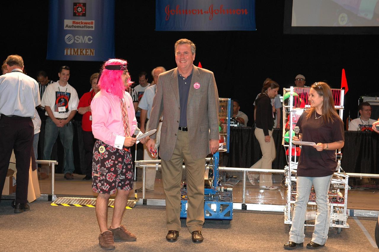 KENNEDY SPACE CENTER, FLA. - Opening ceremonies of the 2006 FIRST Robotics Regional Competition held March 9-11 at the University of Central Florida in Orlando included Florida Governor Jeb Bush (center). At left is Sam Mallikarjunan from Rockledge High School, and at right is Stephanie Alphonso from Freedom High School in Orlando. The FIRST Robotics Competition challenges teams of young people and their mentors to solve a common problem in a six-week timeframe using a standard "kit of parts" and a common set of rules. Teams build robots from the parts and enter them in a series of competitions. FIRST, which is based on "For Inspiration and Recognition of Science and Technology," redefines winning for these students. Teams are rewarded for excellence in design, demonstrated team spirit, gracious professionalism and maturity, and ability to overcome obstacles. Scoring the most points is a secondary goal. Winning means building partnerships that last. NASA and the University of Central Florida are co-sponsors of the regional event, which this year included more than 50 teams. Photo credit: NASA/Kim Shiflett