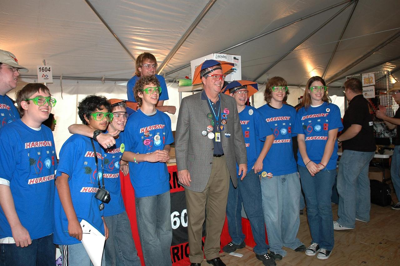KENNEDY SPACE CENTER, FLA.  -  During the 2006 FIRST Robotics Regional Competition held March 9-11 at the University of Central Florida in Orlando, Florida Governor Jeb Bush poses with the student team from Harmony High School in Florida called The Harmony Hurricanes.  The high school was teamed with DeVry University, Disney World and the Town of Harmony.   The FIRST  Robotics Competition challenges teams of young people and their mentors to solve a common problem in a six-week timeframe using a standard "kit of parts" and a common set of rules. Teams build robots from the parts and enter them in a series of competitions.  FIRST, which is based on "For Inspiration and Recognition of Science and Technology," redefines winning for these students. Teams are rewarded for excellence in design, demonstrated team spirit, gracious professionalism and maturity, and ability to overcome obstacles. Scoring the most points is a secondary goal. Winning means building partnerships that last.  NASA and the University of Central Florida are co-sponsors of the regional event, which this year included more than 50 teams.  Photo credit: NASA/Kim Shiflett