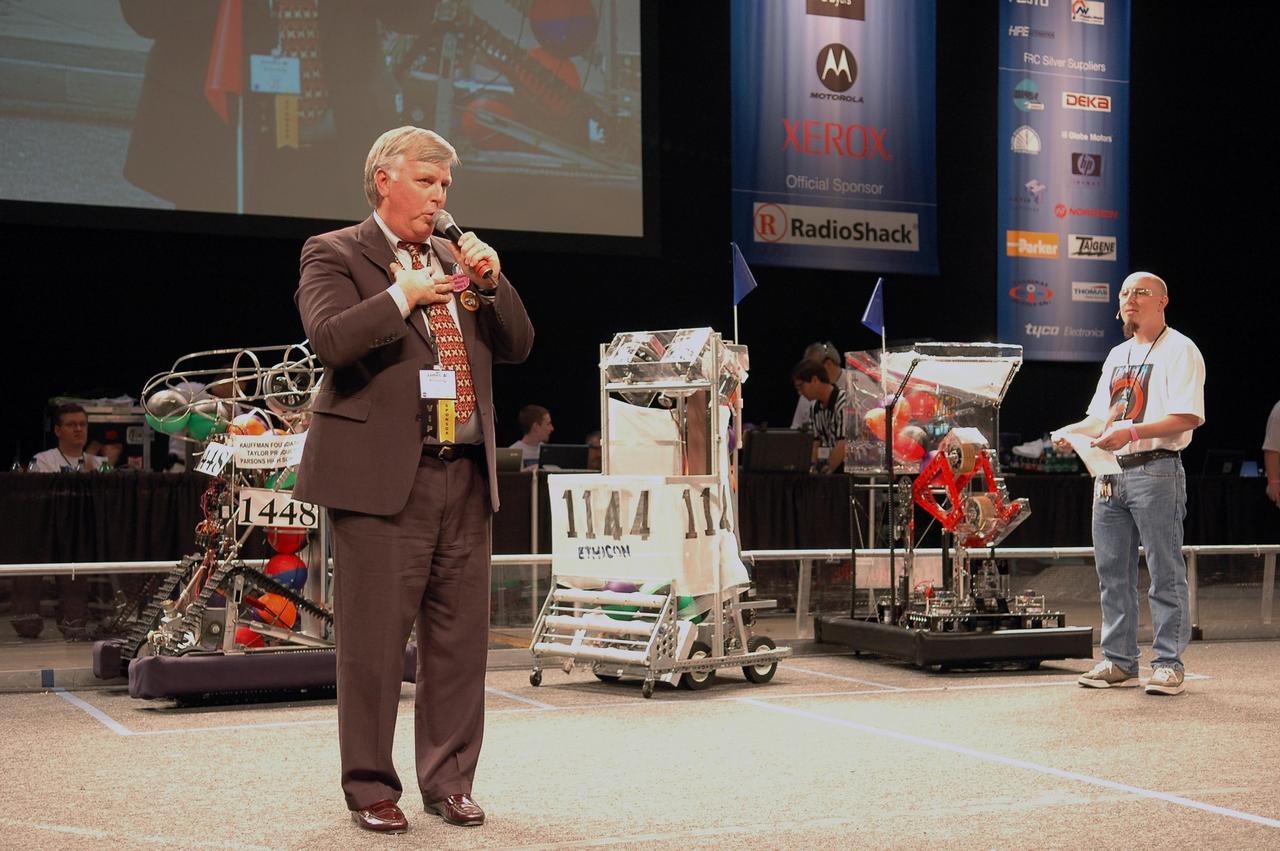 KENNEDY SPACE CENTER, FLA. - During opening ceremonies of the 2006 FIRST Robotics Regional Competition held March 9-11 at the University of Central Florida in Orlando, Kennedy Space Center Director Jim Kennedy talks to the participants. The FIRST Robotics Competition challenges teams of young people and their mentors to solve a common problem in a six-week timeframe using a standard "kit of parts" and a common set of rules. Teams build robots from the parts and enter them in a series of competitions. FIRST, which is based on "For Inspiration and Recognition of Science and Technology," redefines winning for these students. Teams are rewarded for excellence in design, demonstrated team spirit, gracious professionalism and maturity, and ability to overcome obstacles. Scoring the most points is a secondary goal. Winning means building partnerships that last. NASA and the University of Central Florida are co-sponsors of the regional event, which this year included more than 50 teams. Photo credit: NASA/Kim Shiflett
