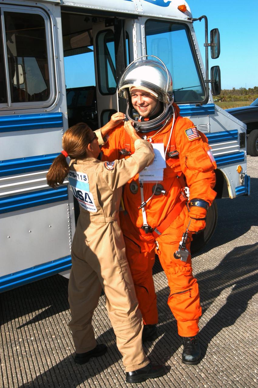 KENNEDY SPACE CENTER, FLA.  -    Preparing for a simulated emergency landing of a shuttle crew,  United Space Alliance (USA) Suit Tech Toni Costa-Davis helps volunteer "astronaut" Brian Bateman, also with USA, with his launch and entry suit.  Many volunteers posed as astronauts during the simulation.  Known as a Mode VI exercise, the operation uses volunteer workers from the Center to pose as astronauts. The purpose of the simulation is to exercise emergency preparedness personnel, equipment and facilities in rescuing astronauts from a downed orbiter and providing immediate medical attention. Photo credit: NASA/George Shelton