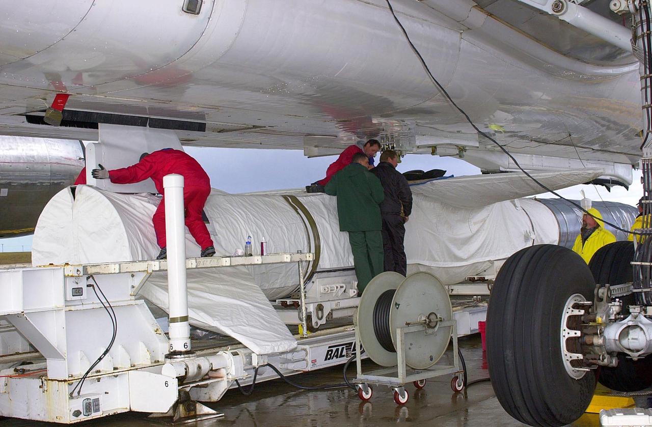 VANDENBERG AIR FORCE BASE, CALIF. - On the ramp adjacent to the runway at Vandenberg Air Force Base in California, a worker positions the vertical fin within the Orbital Sciences L-1011 aircraft. The fin will then be attached to the Space Technology 5's Pegasus rocket which will be mated to the underside of the carrier aircraft. The ST5, which contains three microsatellites with miniaturized redundant components and technologies, is mated to its launch vehicle, Orbital Sciences' Pegasus XL. Each of the ST5 microsatellites will validate New Millennium Program selected technologies, such as the Cold Gas Micro-Thruster and X-Band Transponder Communication System. After deployment from the Pegasus, the micro-satellites will be positioned in a “string of pearls” constellation that demonstrates the ability to position them to perform simultaneous multi-point measurements of the magnetic field using highly sensitive magnetometers. The data will help scientists understand and map the intensity and direction of the Earth’s magnetic field, its relation to space weather events, and affects on our planet. Launch of ST5 and the Pegasus XL will be from underneath the belly of an L-1011 carrier aircraft from Vandenberg Air Force Base.