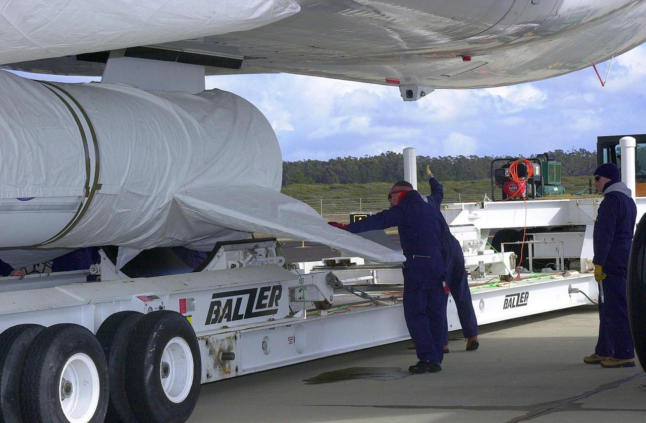 VANDENBERG AIR FORCE BASE, CALIF. - On the ramp adjacent to the runway at Vandenberg Air Force Base in California, workers secure the Space Technology 5's Pegasus rocket to the underside of an Orbital Sciences L-1011 carrier aircraft. The ST5, which contains three microsatellites with miniaturized redundant components and technologies, is mated to its launch vehicle, Orbital Sciences' Pegasus XL. Each of the ST5 microsatellites will validate New Millennium Program selected technologies, such as the Cold Gas Micro-Thruster and X-Band Transponder Communication System. After deployment from the Pegasus, the micro-satellites will be positioned in a “string of pearls” constellation that demonstrates the ability to position them to perform simultaneous multi-point measurements of the magnetic field using highly sensitive magnetometers. The data will help scientists understand and map the intensity and direction of the Earth’s magnetic field, its relation to space weather events, and affects on our planet. Launch of ST5 and the Pegasus XL will be from underneath the belly of an L-1011 carrier aircraft from Vandenberg Air Force Base.