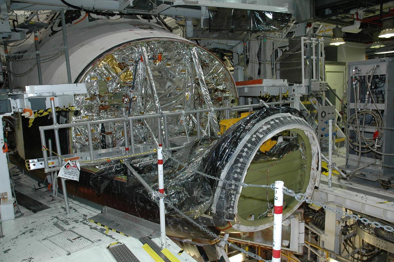 KENNEDY SPACE CENTER, FLA. -   In Orbiter Processing Facility bay 2 at NASA's Kennedy Space Center, Endeavour waits for installation of its reinforced carbon-carbon nose cap.  The nose cap is insulated with thermal protection system blankets made of a woven ceramic fabric.  The special blankets help insulate the vehicle's nose cap and protect it from the extreme temperatures it will face during a mission.  Photo credit: NASA/Jim Grossmann