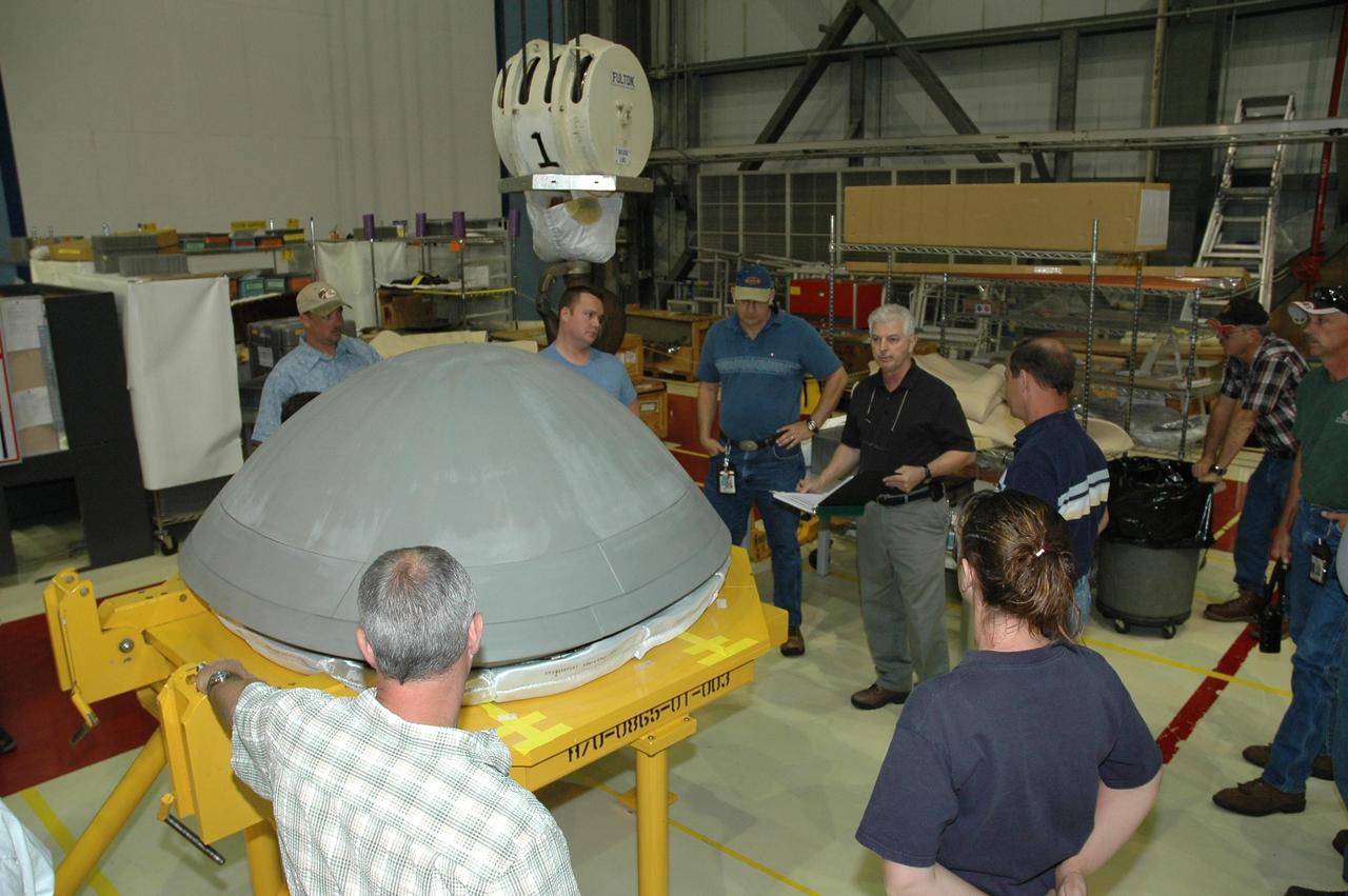 KENNEDY SPACE CENTER, FLA. -   In Orbiter Processing Facility bay 2 at NASA's Kennedy Space Center, workers are preparing to move and install the reinforced carbon-carbon nose cap (on the stand) onto Endeavour.  The nose cap is insulated with thermal protection system blankets made of a woven ceramic fabric.  The special blankets help insulate the vehicle's nose cap and protect it from the extreme temperatures it will face during a mission.  Photo credit: NASA/Jim Grossmann
