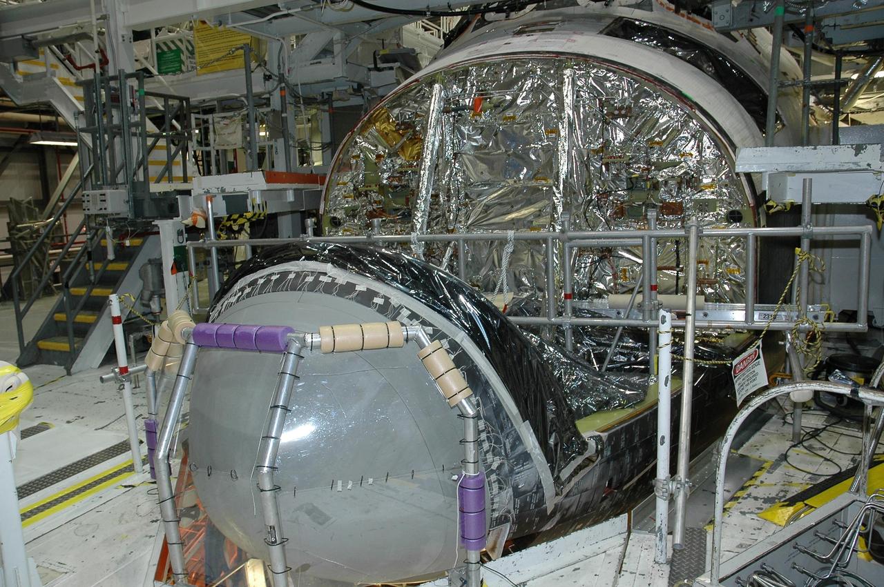 KENNEDY SPACE CENTER, FLA. -  In Orbiter Processing Facility bay 2 at NASA's Kennedy Space Center, the reinforced carbon-carbon nose cap has been installed on Endeavour.  The nose cap has been insulated with thermal protection system blankets made of a woven ceramic fabric.  The special blankets help insulate the vehicle's nose cap and protect it from the extreme temperatures it will face during a mission. Photo credit: NASA/Jim Grossmann