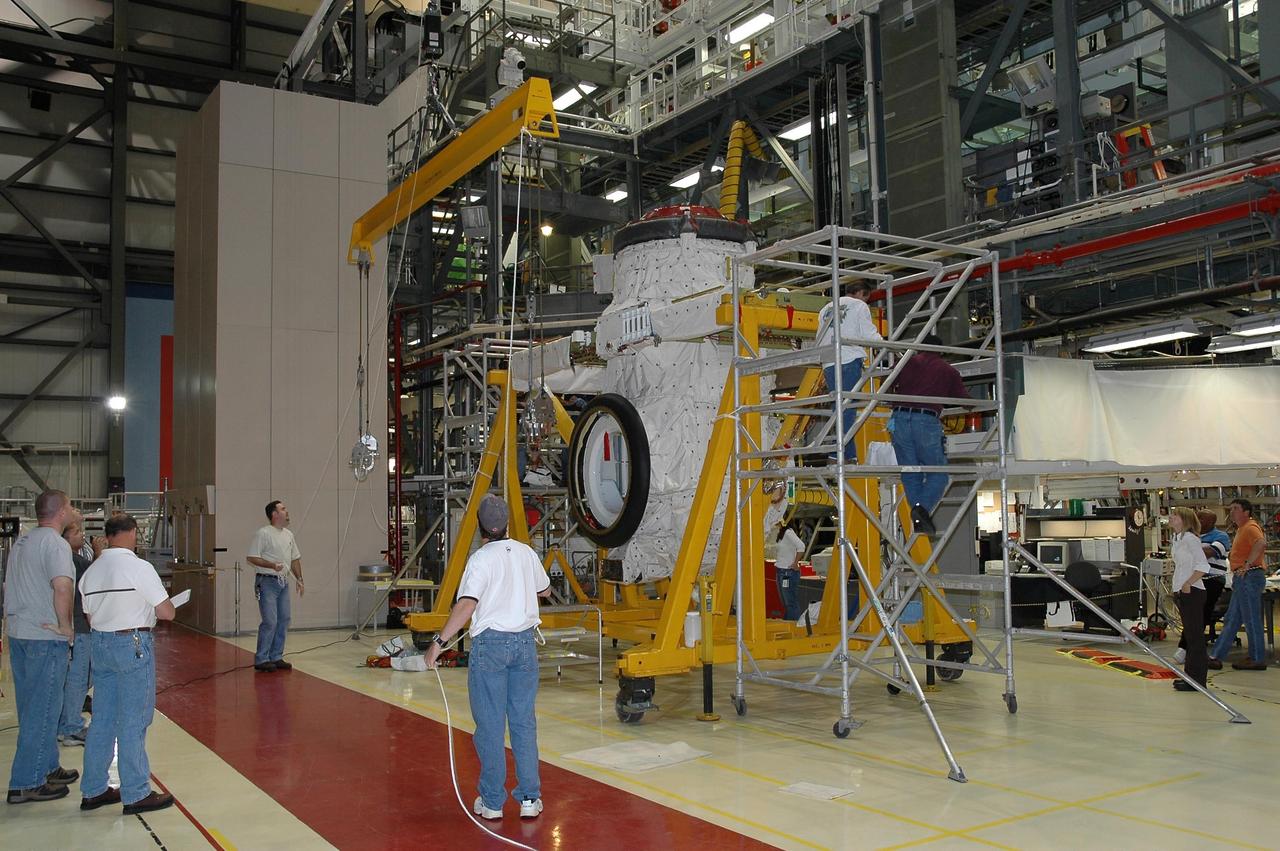 KENNEDY SPACE CENTER, FLA. - In Orbiter Processing Facility bay 2 at NASA's Kennedy Space Center, the airlock is being lifted for installation in Endeavour's payload bay. The airlock is located in the middeck. The airlock and airlock hatches permit flight crew members to transfer from the middeck crew compartment into the payload bay for extravehicular activities in their space suits without depressurizing the orbiter crew cabin. The airlock is sized to accommodate two fully suited flight crew members simultaneously. Photo credit: NASA/Jim Grossmann