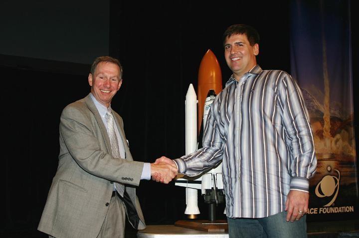 KENNEDY SPACE CENTER, FLA. -  NASA Administrator Mike Griffin (left) and HDNet Chairman and President Mark Cuban shake hands after announcing an agreement for HDNet to provide high definition TV coverage of space shuttle launches through 2010.  The announcement was made at a news conference held in Colorado Springs, Colo.  The news conference was hosted by the Space Foundation during its 22nd National Space Symposium that ended today.   HDNet will broadcast the shuttle flights in high definition TV, known as HDTV, which has at least twice the resolution of standard television formats. HDNet also will provide the agency a standard broadcast signal of launches for use by media networks and NASA TV. When possible, it will air HDTV coverage of NASA's expendable rocket launches on its network.