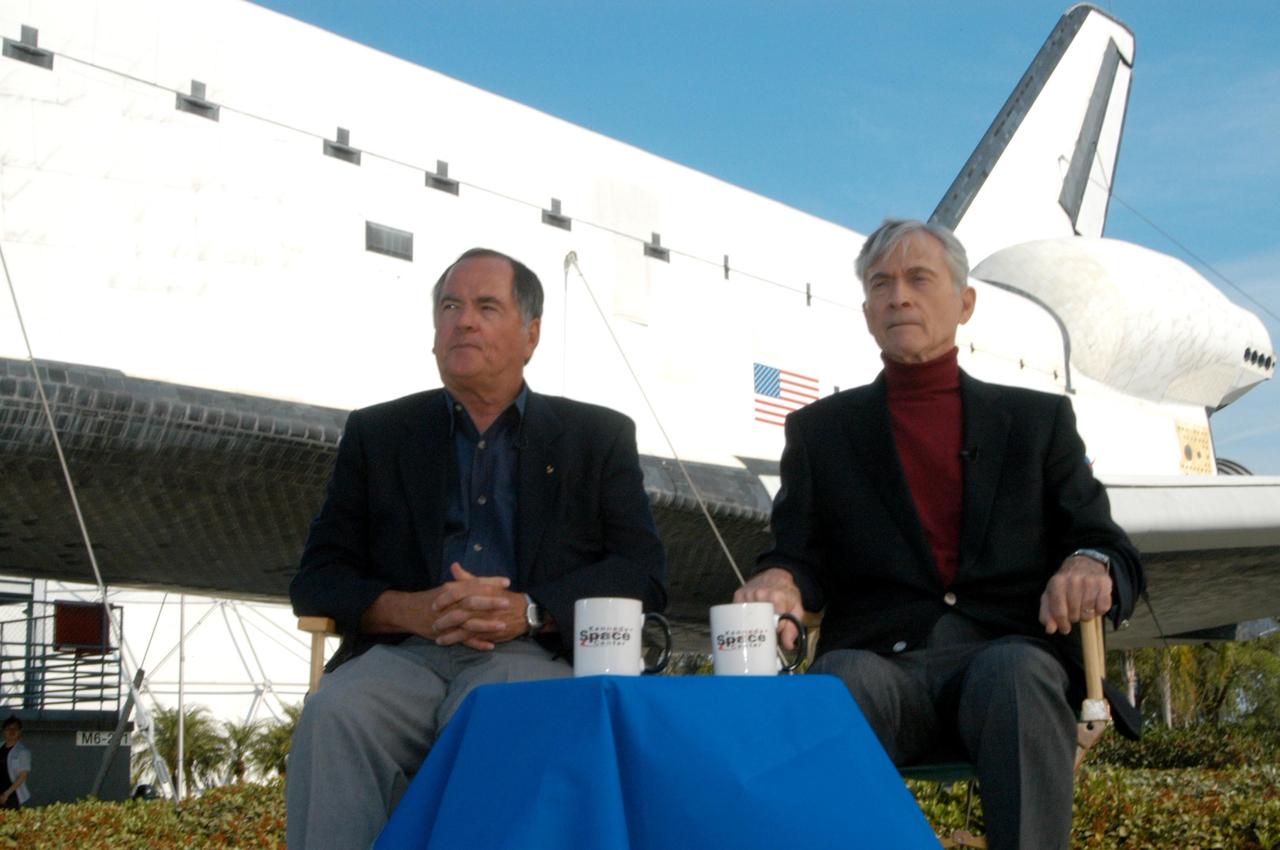 KENNEDY SPACE CENTER, FLA. - To honor the 25th anniversary of the first shuttle launch on April 12, 1981, STS-1 Pilot Bob Crippen (left) and Commander John Young (right) sit in front of a mockup of a space shuttle at the Kennedy Space Center Visitor Complex. During their appearance, they shared their experiences on that historic flight. Photo credit: NASA/George Shelton