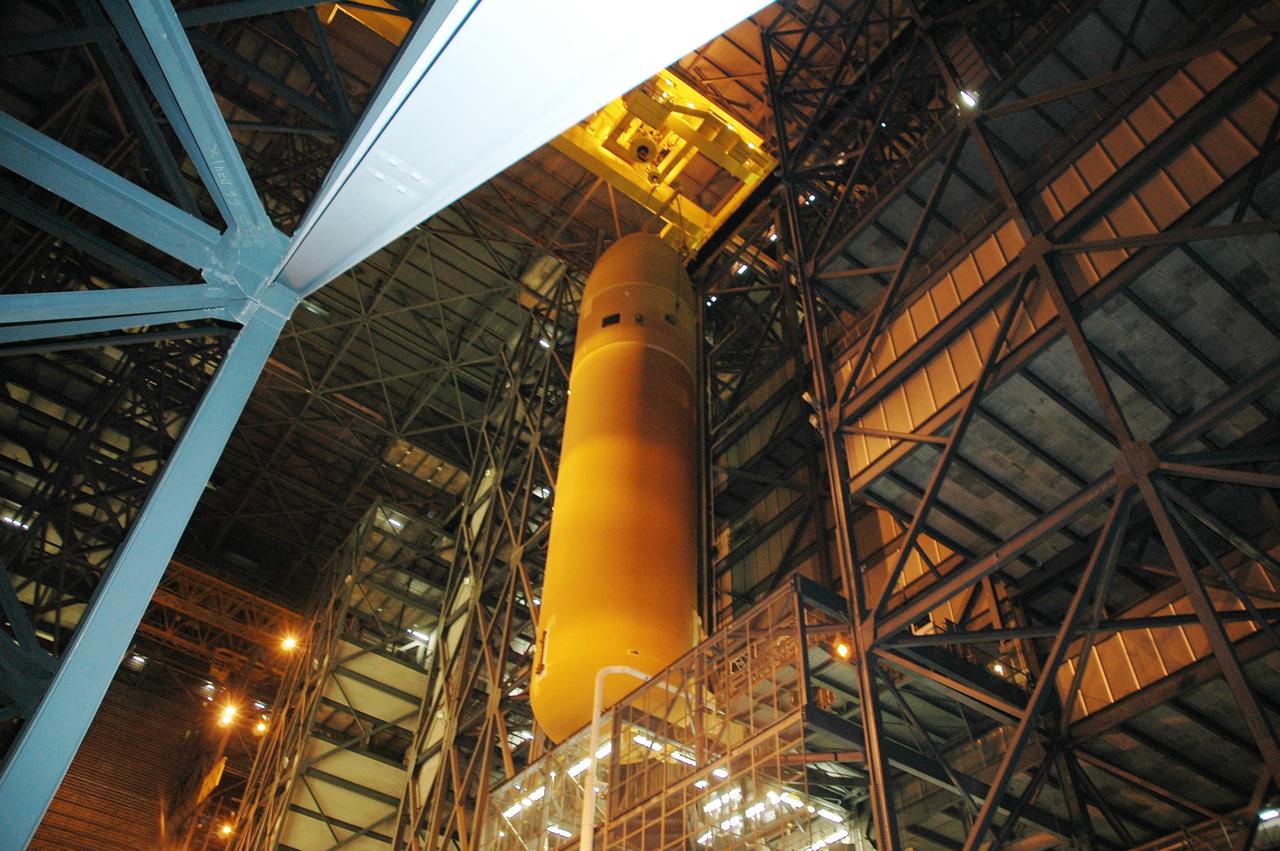 KENNEDY SPACE CENTER, FLA.  -  Inside the Vehicle Assembly Building at NASA's Kennedy Space Center, external tank number 119 is being moved from the checkout cell and will be placed horizontally on the transporter in the transfer aisle. Once in the transfer aisle, technicians will reapply the thermal protection system foam that was removed in order to replace the tank's four liquid hydrogen engine cutoff sensors. The tank is being prepared to launch Space Shuttle Discovery on mission STS-121 in July.   Photo credit: NASA/Cory Huston