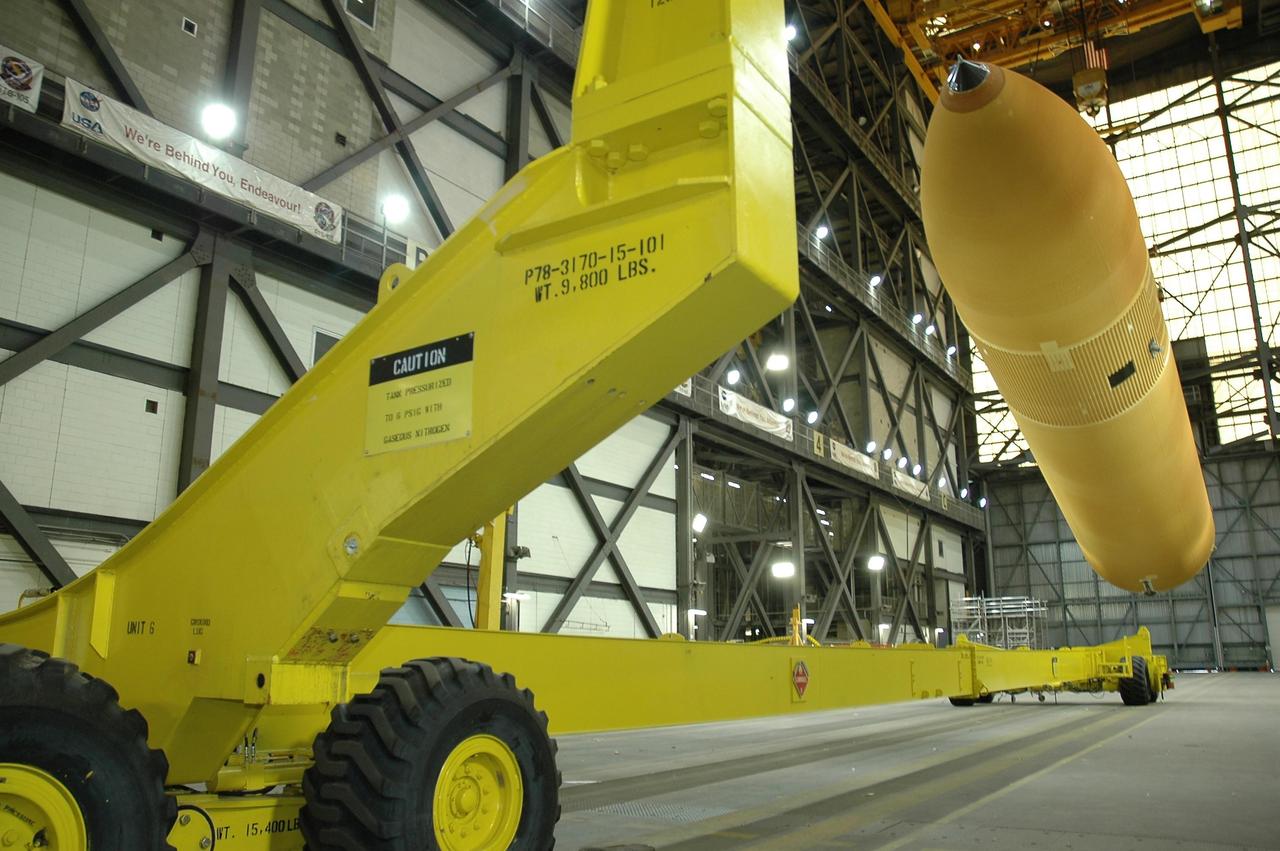 KENNEDY SPACE CENTER, FLA.  -  Inside the Vehicle Assembly Building at NASA's Kennedy Space Center, external tank number 119 is shifted to a horizontal position for placement on the transporter at left where technicians will reapply the thermal protection system foam that was removed in order to replace the tank's four liquid hydrogen engine cutoff sensors. The tank is being prepared to launch Space Shuttle Discovery on mission STS-121 in July.  Photo credit: NASA/Cory Huston