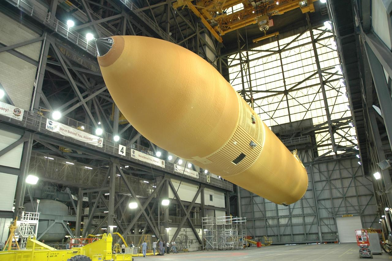 KENNEDY SPACE CENTER, FLA.  -  Inside the Vehicle Assembly Building at NASA's Kennedy Space Center, external tank number 119 hangs suspended horizontally.  It will be lowered onto the transporter at lower left where technicians will reapply the thermal protection system foam that was removed in order to replace the tank's four liquid hydrogen engine cutoff sensors. The tank is being prepared to launch Space Shuttle Discovery on mission STS-121 in July.  Photo credit: NASA/Cory Huston
