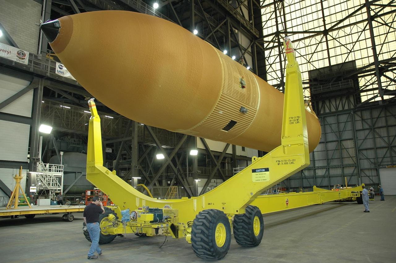 KENNEDY SPACE CENTER, FLA.  -  Inside the Vehicle Assembly Building at NASA's Kennedy Space Center, external tank number 119 is lowered onto a transporter where technicians will reapply the thermal protection system foam that was removed in order to replace the tank's four liquid hydrogen engine cutoff sensors. The tank is being prepared to launch Space Shuttle Discovery on mission STS-121 in July.  Photo credit: NASA/Cory Huston