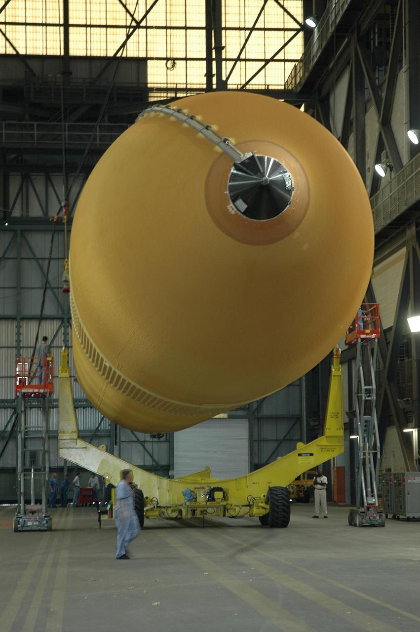 KENNEDY SPACE CENTER, FLA.  -  Inside the Vehicle Assembly Building at NASA's Kennedy Space Center, external tank number 119 is lowered onto a transporter where technicians will reapply the thermal protection system foam that was removed in order to replace the tank's four liquid hydrogen engine cutoff sensors. The tank is being prepared to launch Space Shuttle Discovery on mission STS-121 in July.  Photo credit: NASA/Cory Huston