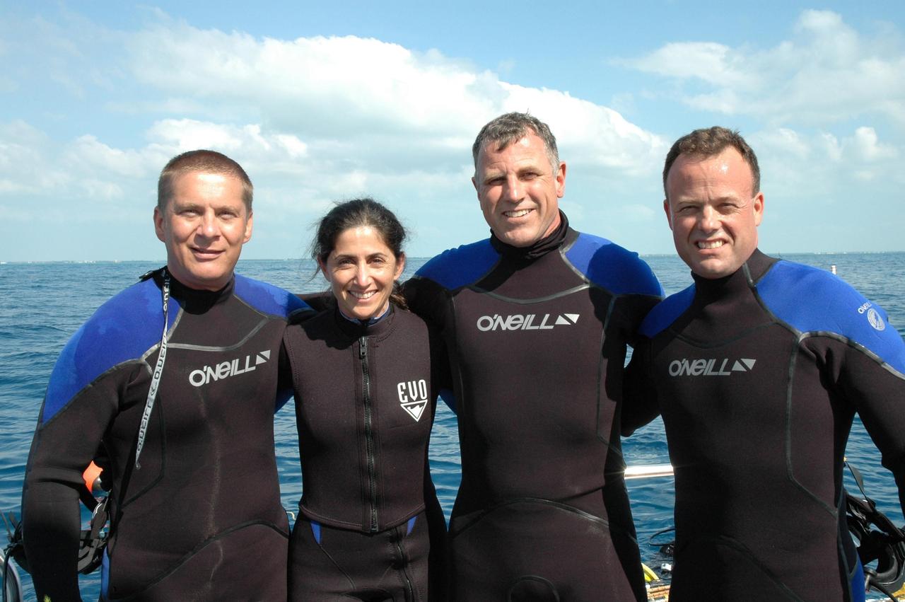 KENNEDY SPACE CENTER, FLA. -- The NASA Extreme Environment Mission Operations (NEEMO) team is ready to begin their 17-day undersea mission in the National Oceanic and Atmospheric Administration (NOAA) Aquarius Underwater Laboratory. From left are Dr. Tim Broderick of the University of Cincinnati and astronauts Nicole Stott, Dave Williams (team lead) and Ron Garan. The astronauts are testing space medicine concepts and moon-walking techniques. The undersea laboratory is situated three miles off Key Largo in the Florida Keys National Marine Sanctuary, anchored 62 feet below the surface.