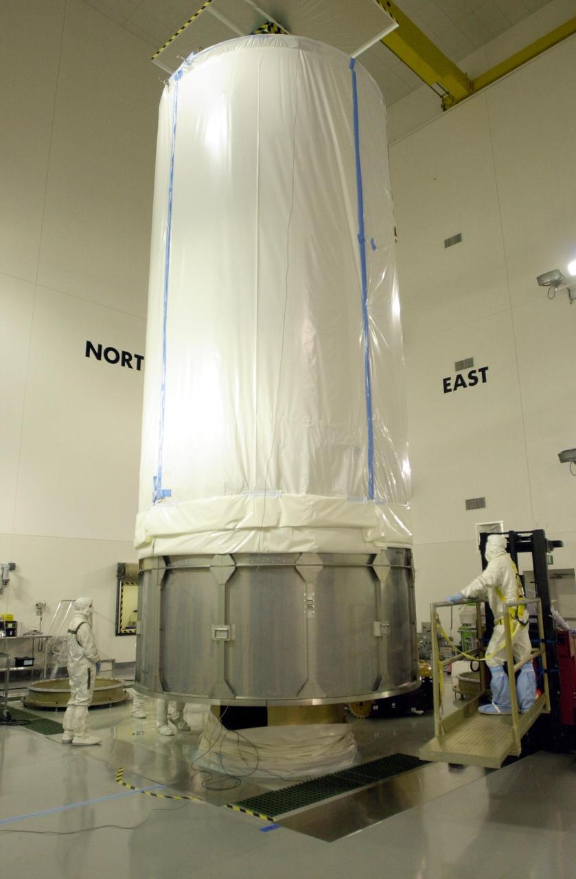 VANDENBERG AIR FORCE BASE, Calif. - Inside the Astrotech Payload Processing Facility on Vandenberg Air Force Base in California, the transport canister covers the dual spacecraft CALIPSO and CloudSat. The spacecraft will be moved to Space Launch Complex 2. There the spacecraft will be lifted and mated with a Boeing Delta II rocket for launch on April 21. CALIPSO stands for Cloud-Aerosol Lidar and Infrared Pathfinder Satellite Observation. It will fly in combination with the CloudSat satellite to provide never-before-seen 3-D perspectives of how clouds and aerosols form, evolve, and affect weather and climate. CALIPSO and CloudSat will join three other satellites in orbit to enhance understanding of climate systems.