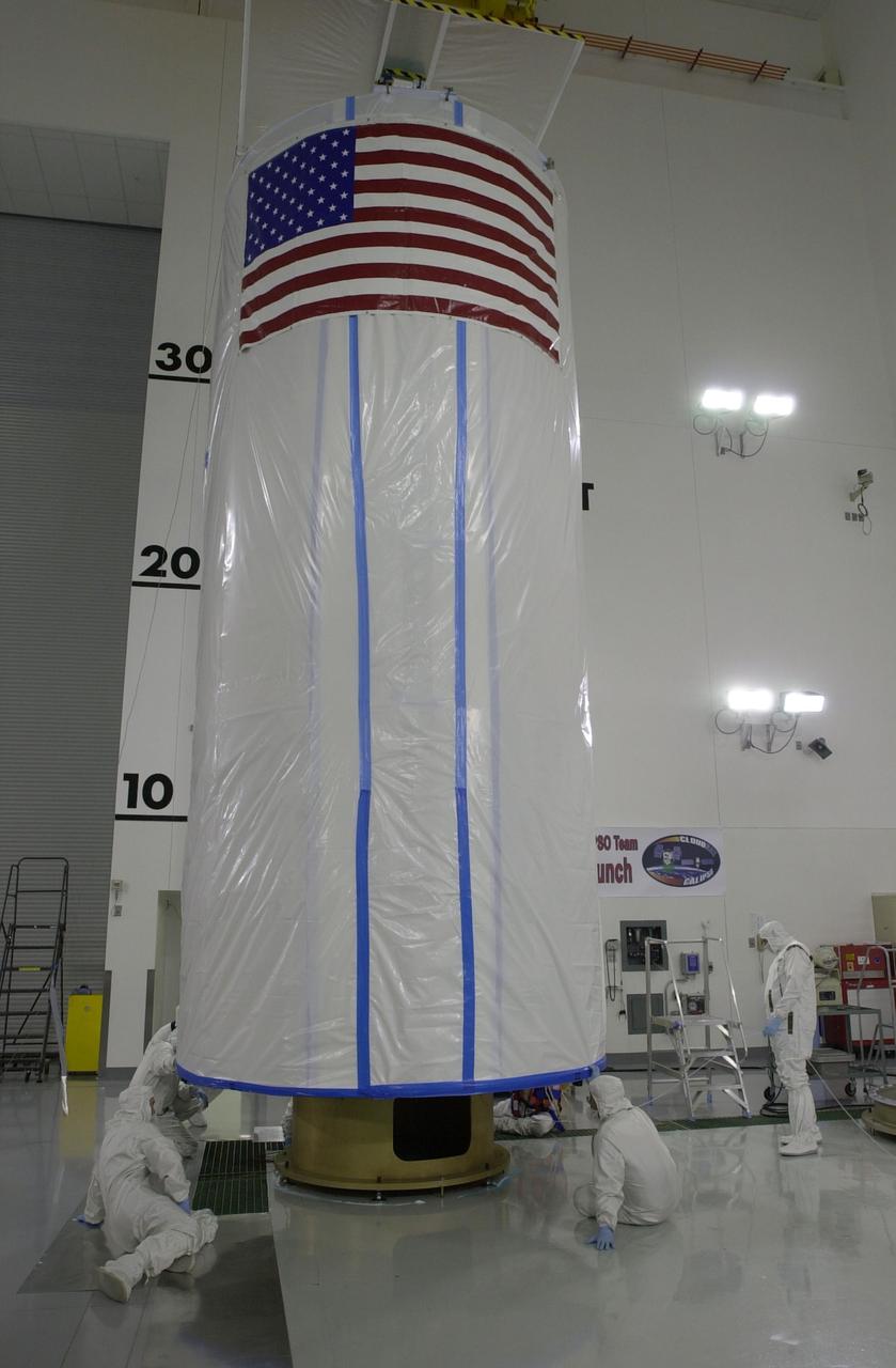 VANDENBERG AIR FORCE BASE, Calif. - Inside the Astrotech Payload Processing Facility on Vandenberg Air Force Base in California, workers secure the transport canister around the dual spacecraft CALIPSO and CloudSat. The spacecraft will be moved to Space Launch Complex 2. There the spacecraft will be lifted and mated with a Boeing Delta II rocket for launch on April 21. CALIPSO stands for Cloud-Aerosol Lidar and Infrared Pathfinder Satellite Observation. It will fly in combination with the CloudSat satellite to provide never-before-seen 3-D perspectives of how clouds and aerosols form, evolve, and affect weather and climate. CALIPSO and CloudSat will join three other satellites in orbit to enhance understanding of climate systems.