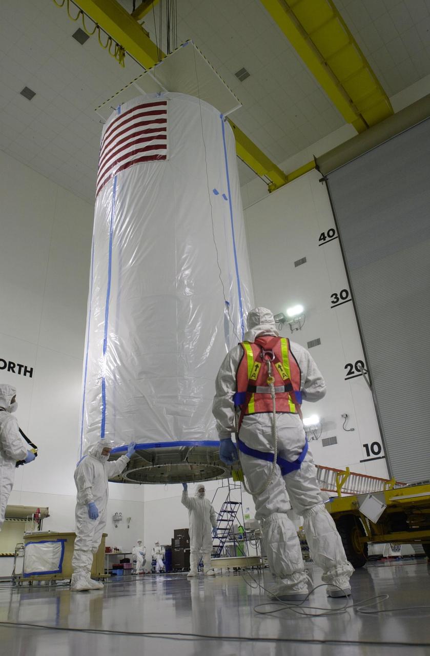 VANDENBERG AIR FORCE BASE, Calif. - Inside the Astrotech Payload Processing Facility on Vandenberg Air Force Base in California, a crane lifts the transport canister covering the dual spacecraft CALIPSO and CloudSat. The spacecraft is being moved to Space Launch Complex 2. There the spacecraft will be lifted and mated with a Boeing Delta II rocket for launch on April 21. CALIPSO stands for Cloud-Aerosol Lidar and Infrared Pathfinder Satellite Observation. It will fly in combination with the CloudSat satellite to provide never-before-seen 3-D perspectives of how clouds and aerosols form, evolve, and affect weather and climate. CALIPSO and CloudSat will join three other satellites in orbit to enhance understanding of climate systems.