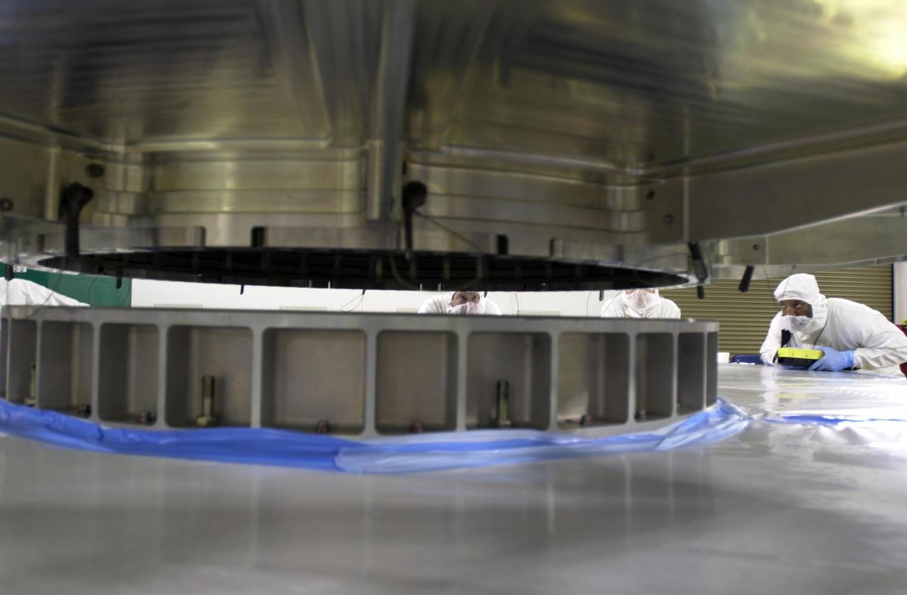 VANDENBERG AIR FORCE BASE, Calif. - Inside the Astrotech Payload Processing Facility on Vandenberg Air Force Base in California, the dual spacecraft CALIPSO and CloudSat, covered by a transport canister, is lowered onto a payload transporter. The spacecraft is being moved to Space Launch Complex 2. There the spacecraft will be lifted and mated with a Boeing Delta II rocket for launch on April 21. CALIPSO stands for Cloud-Aerosol Lidar and Infrared Pathfinder Satellite Observation. It will fly in combination with the CloudSat satellite to provide never-before-seen 3-D perspectives of how clouds and aerosols form, evolve, and affect weather and climate. CALIPSO and CloudSat will join three other satellites in orbit to enhance understanding of climate systems. Launch of CALIPSO/CloudSat is scheduled for April 21.