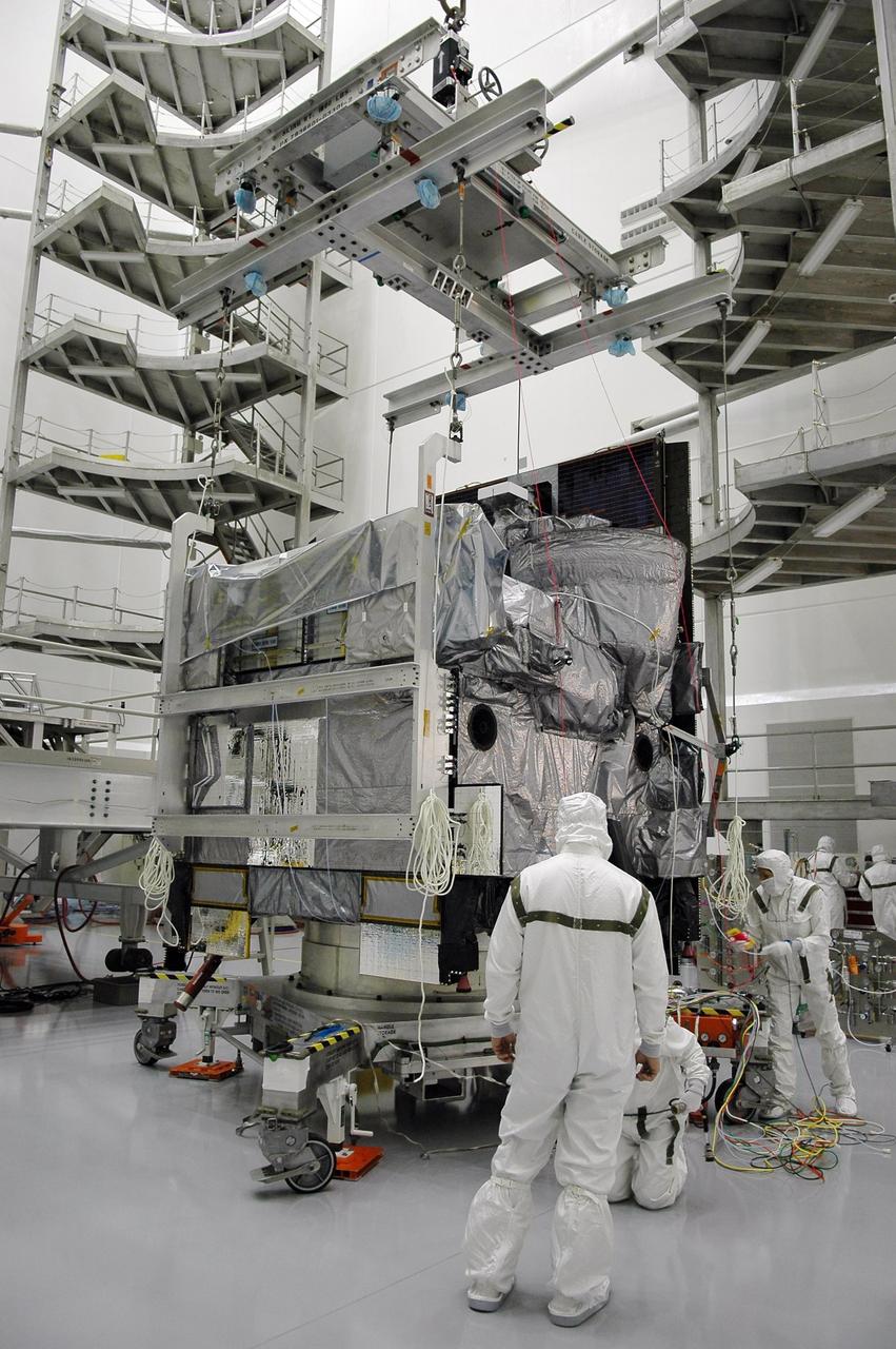KENNEDY SPACE CENTER, FLA. - Inside a high bay at Astrotech Space Operations in Titusville, Fla., the GOES-N spacecraft is attached to an overhead crane. The spacecraft will be lifted and moved for mating with its payload adapter. GOES-N is the latest in a series of Geostationary Operational Environmental Satellites for NOAA and NASA providing continuous monitoring necessary for intensive data analysis. It will be launched May 18 on a Boeing Delta IV rocket from Cape Canaveral Air Force Station in Florida. Photo credit: NASA/Kim Shiflett