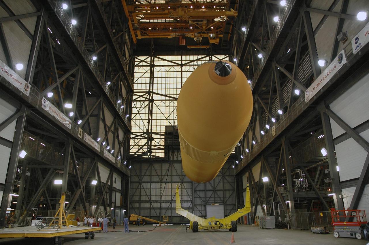 KENNEDY SPACE CENTER, FLA.  - In the Vehicle Assembly Building's transfer aisle at NASA's Kennedy Space Center, external tank No. 119 is lifted off its transporter.  The tank will be raised to vertical and lifted into high bay 3 for stacking with solid rocket boosters.  The tank and boosters will launch Space Shuttle Discovery on mission STS-121 in July.  Photo credit: NASA/Jack Pfaller