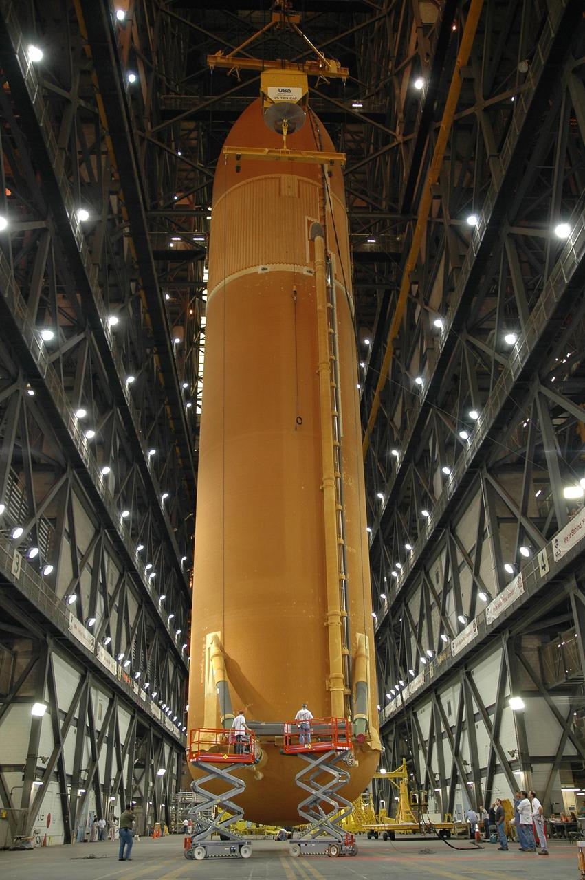 KENNEDY SPACE CENTER, FLA.  - In the Vehicle Assembly Building's transfer aisle at NASA's Kennedy Space Center, external tank No. 119 is suspended in a vertical position. The tank will lifted into high bay 3 for stacking with solid rocket boosters. The tank and boosters will launch Space Shuttle Discovery on mission STS-121 in July.  Photo credit: NASA/Jack Pfaller