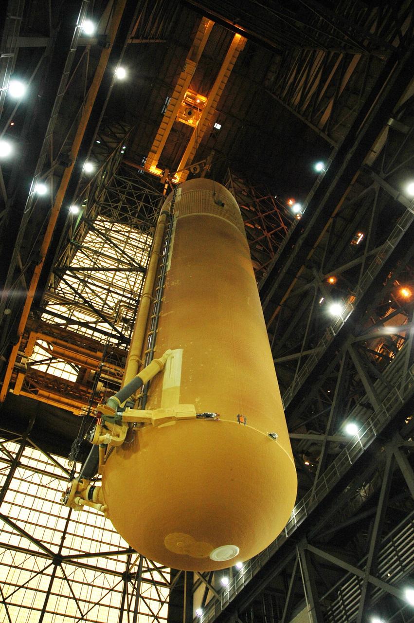 KENNEDY SPACE CENTER, FLA.  -  In the transfer aisle of the Vehicle Assembly Building, the external tank designated for Space Shuttle Discovery is lifted by crane off its transporter for the move to high bay 3. There it will be stacked with the solid rocket boosters already in place on the mobile launcher platform.  Discovery is scheduled to launch on mission STS-121 in July.  Photo credit: NASA/Amanda Diller