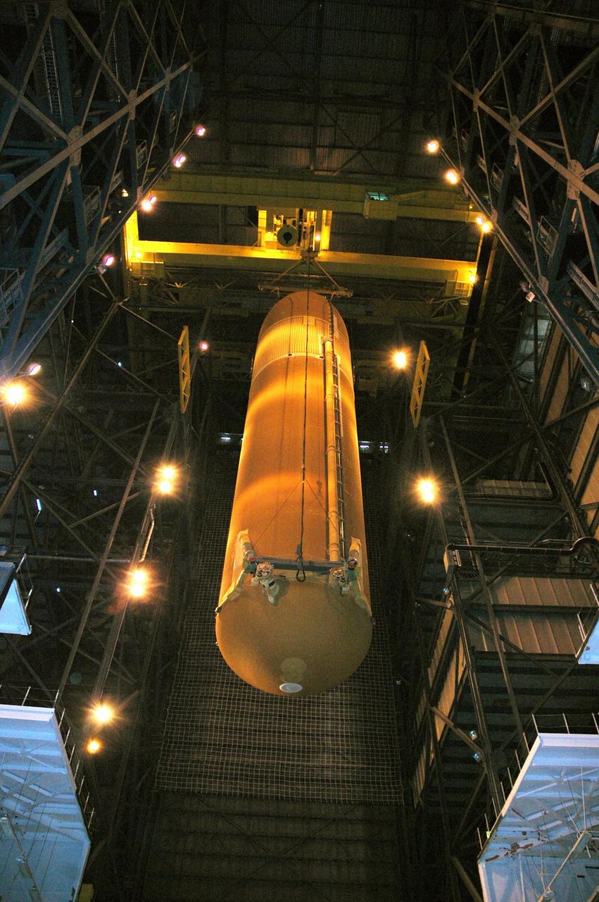KENNEDY SPACE CENTER, FLA. - In the Vehicle Assembly Building, the external tank designated for Space Shuttle Discovery is lowered into high bay 3. There it will be stacked with the solid rocket boosters already in place on the mobile launcher platform. Discovery is scheduled to launch on mission STS-121 in July. Photo credit: NASA/Amanda Diller